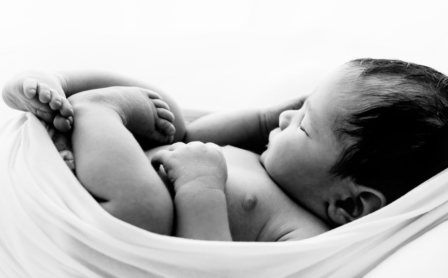A newborn close up image with the baby wrapped during a Newborn studio photography session in Corby, Northamptonshire