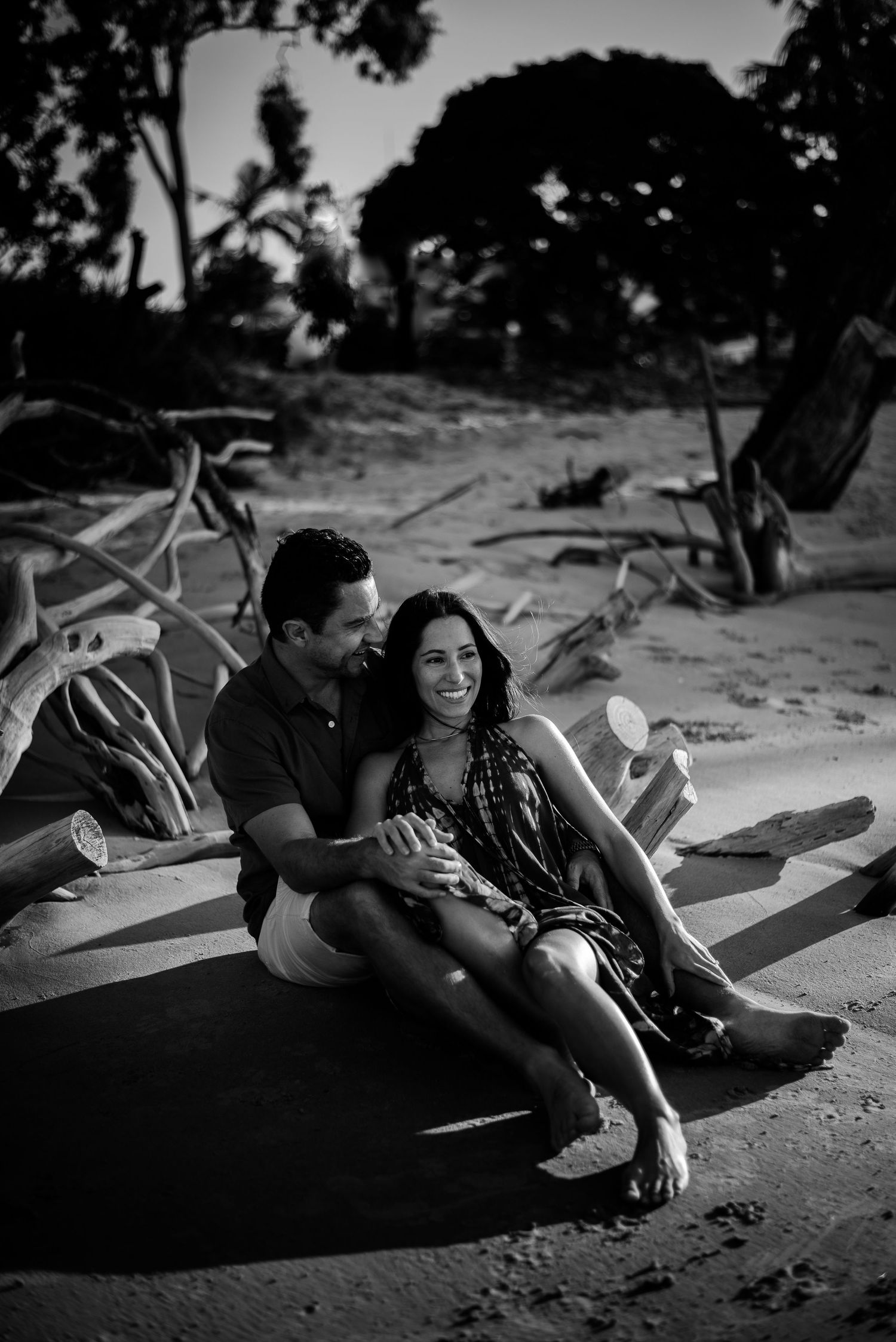 engaged couple smiling and cuddling at the beach, cairns © 2025 Jenna Hennessy / The Tone Curve