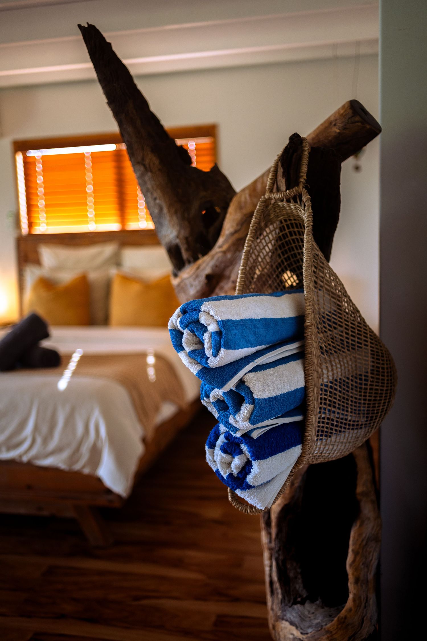 towels hanging with bed in background of a luxe stay, air bnb, Mareeba cairns air bnb photographer, boutique accommodation