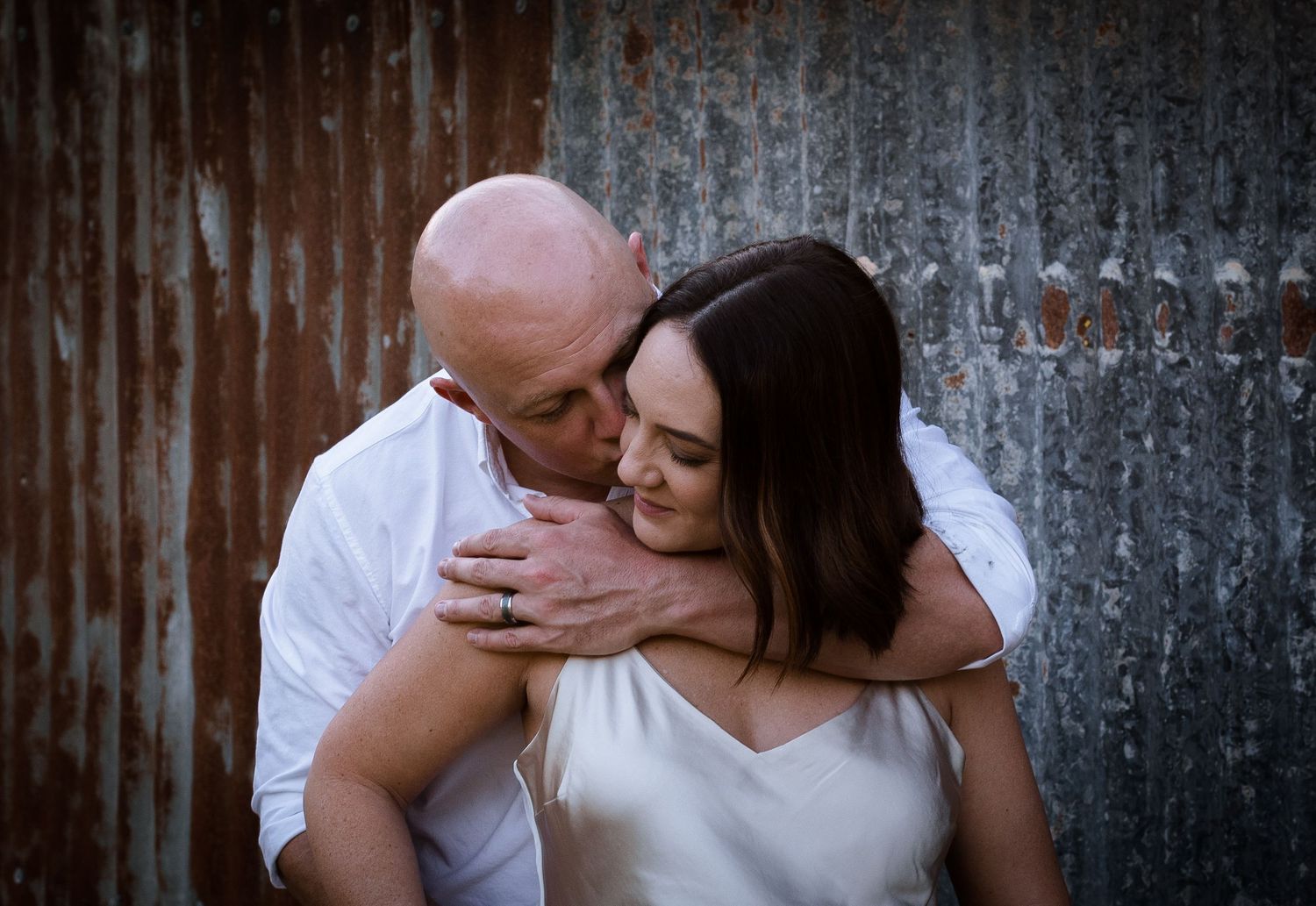 couple kissing next to a shed on a farm in cairns © 2025 Jenna Hennessy / The Tone Curve