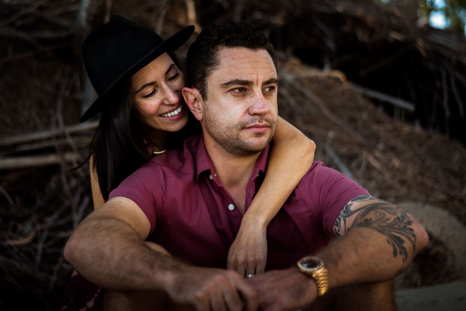 couple posing, smiling at beach cairns © 2025 Jenna Hennessy / The Tone Curve
