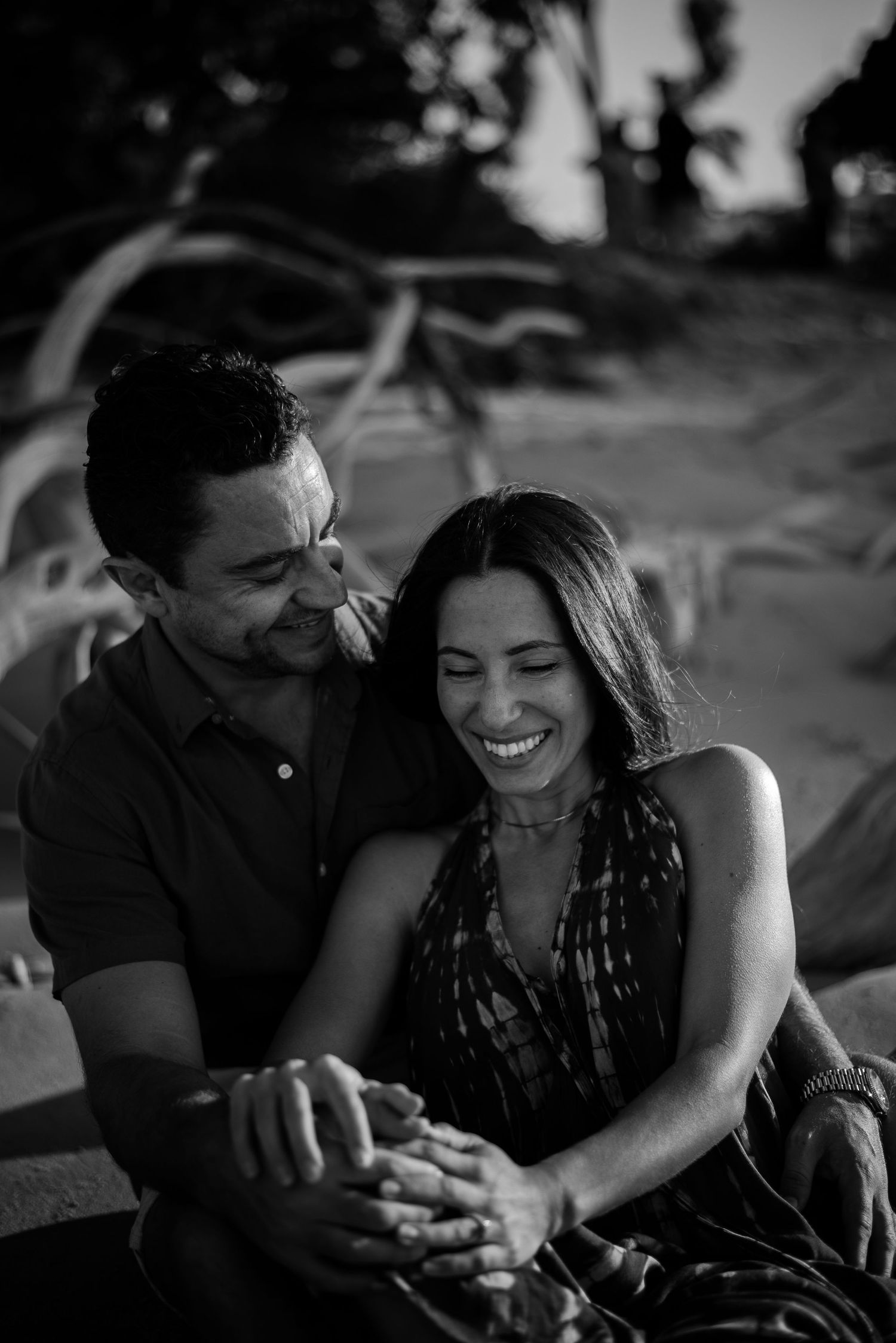 engaged couple laughing at the beach, cairns © 2025 Jenna Hennessy / The Tone Curve