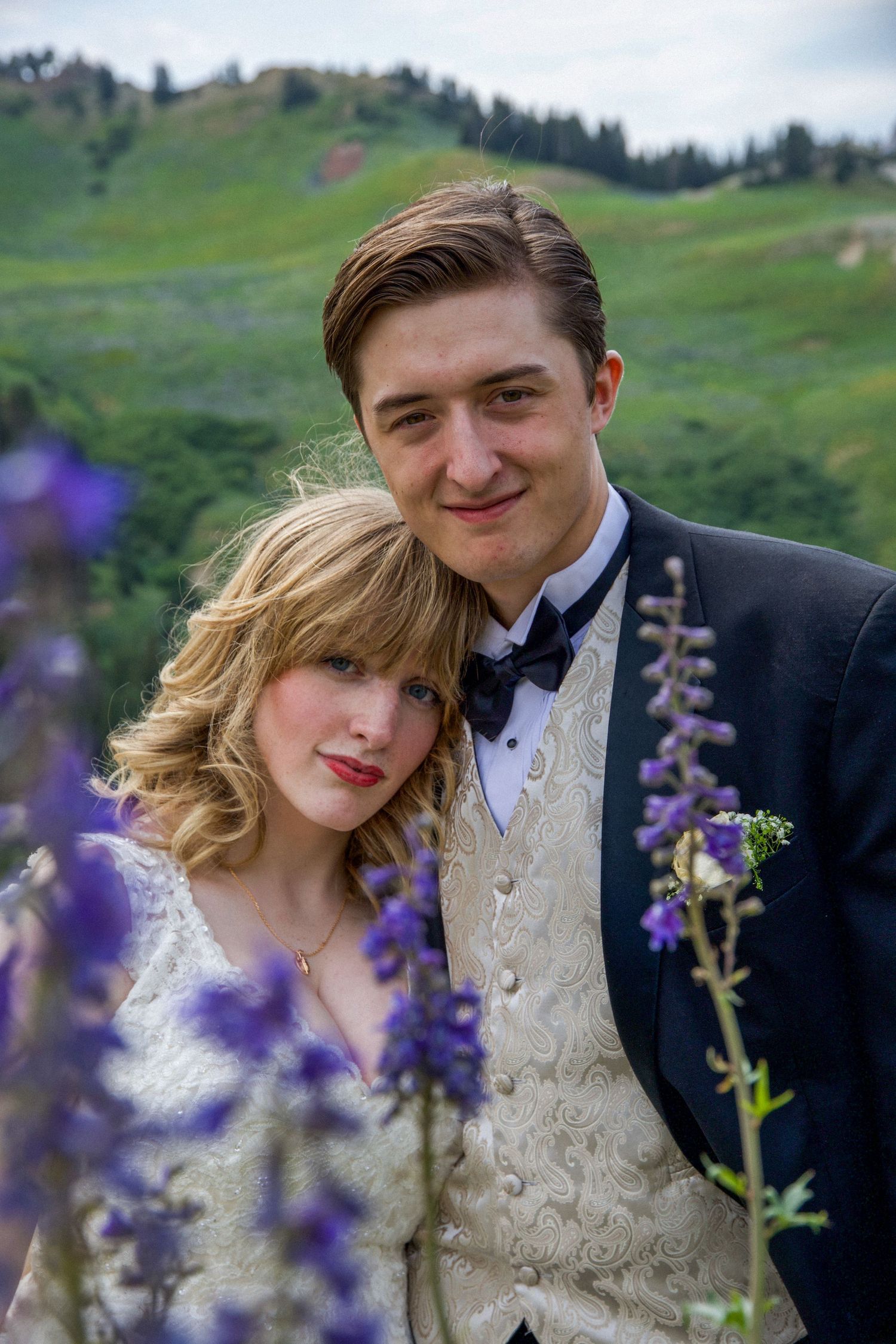 A married couple in the field of wild flowers in Albion Basin, Alta, Utah.
