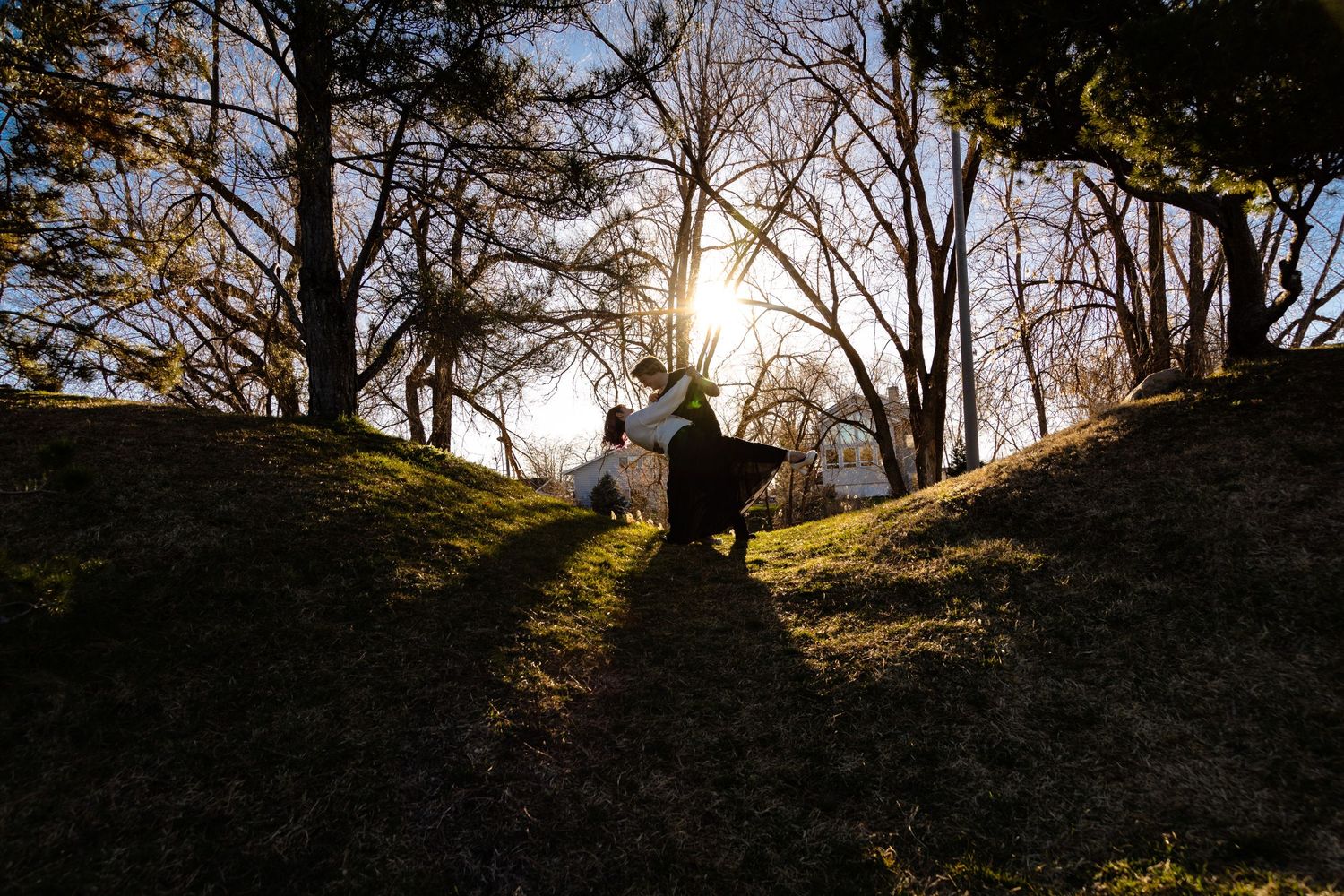 A couple dancing in a sunset glow in International Piece Gardens in Salt Lake City, Utah.