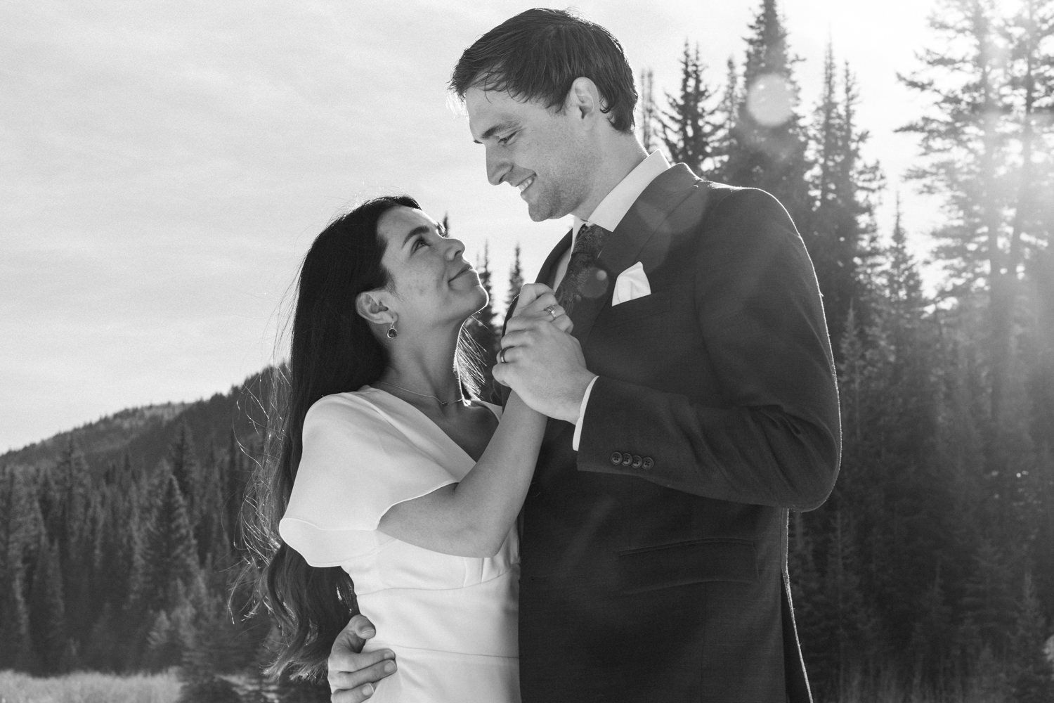 A back and white photo of a coupe during their elopement session looking tenderly into each other's eyes.