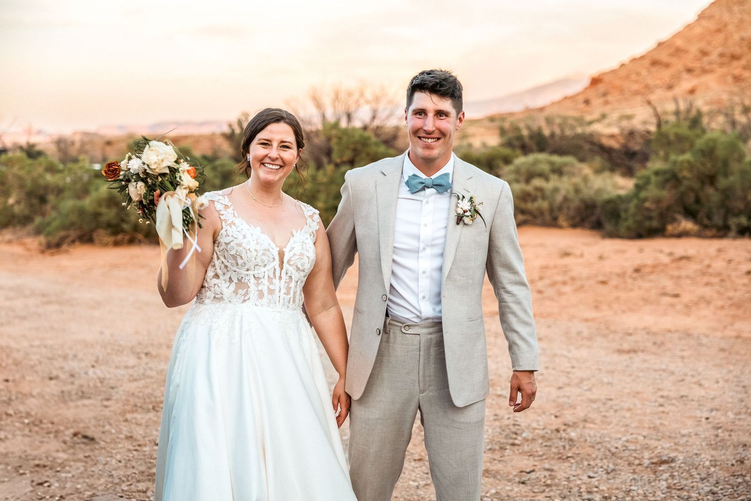 A bride and groom holding hands right after their wedding ceremony in Moab, Utah.