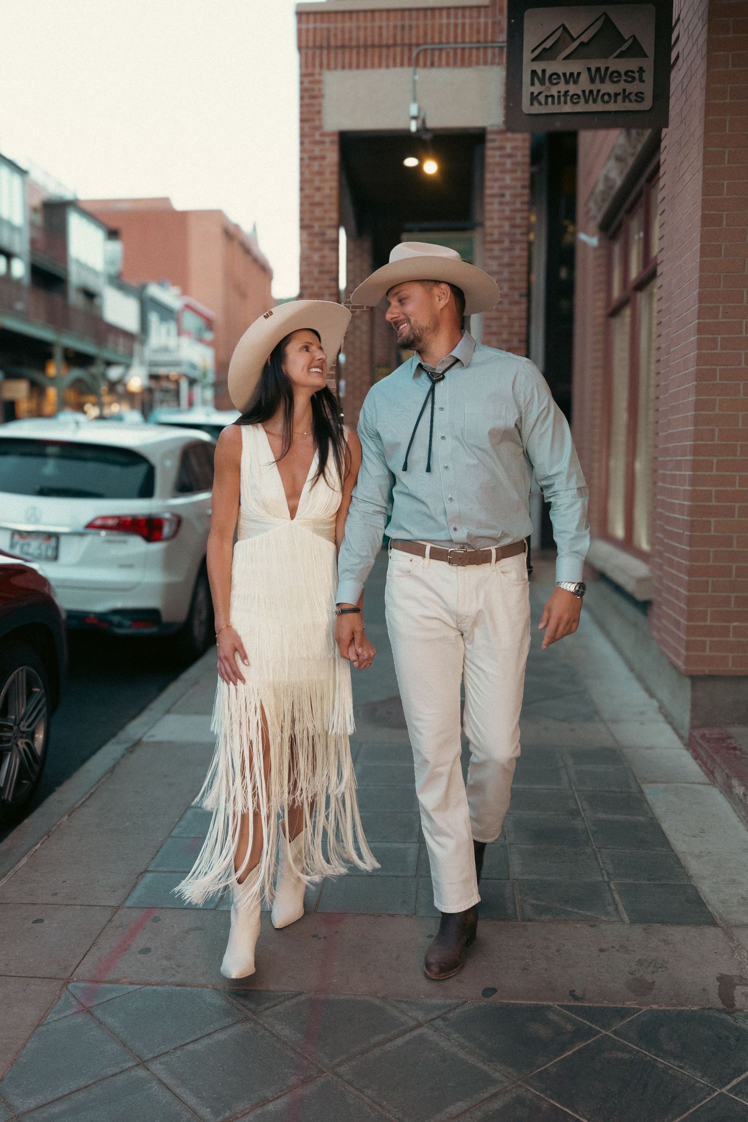 A married couple to be during their night before the wedding celebrations walking down the Main Street in Park City, Utah.