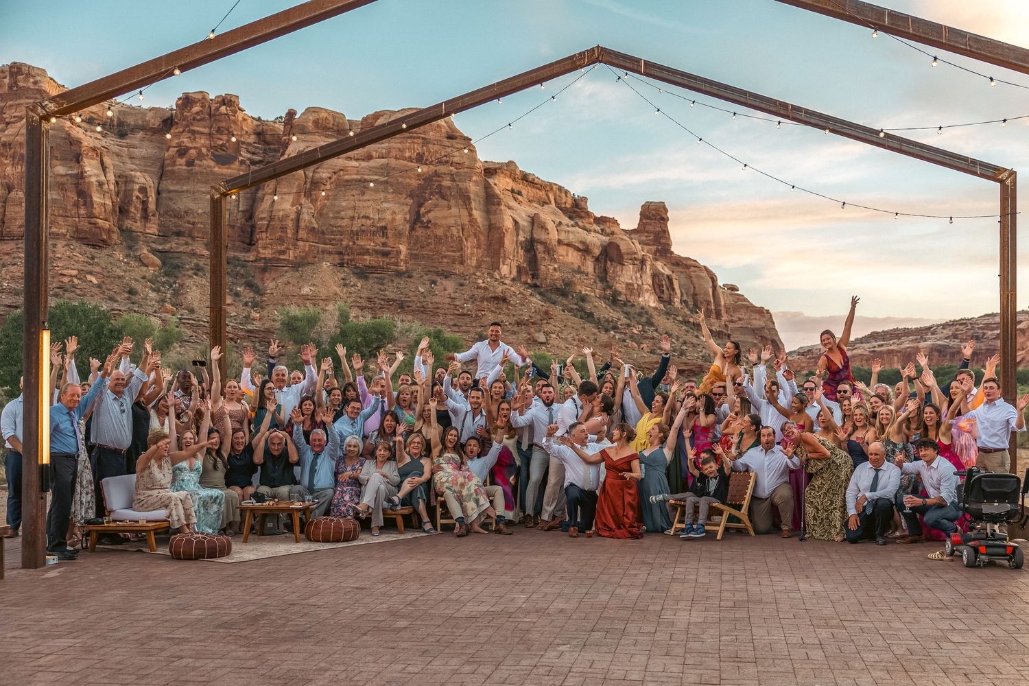 A wedding party group photo at sunset in Moab, Utah.