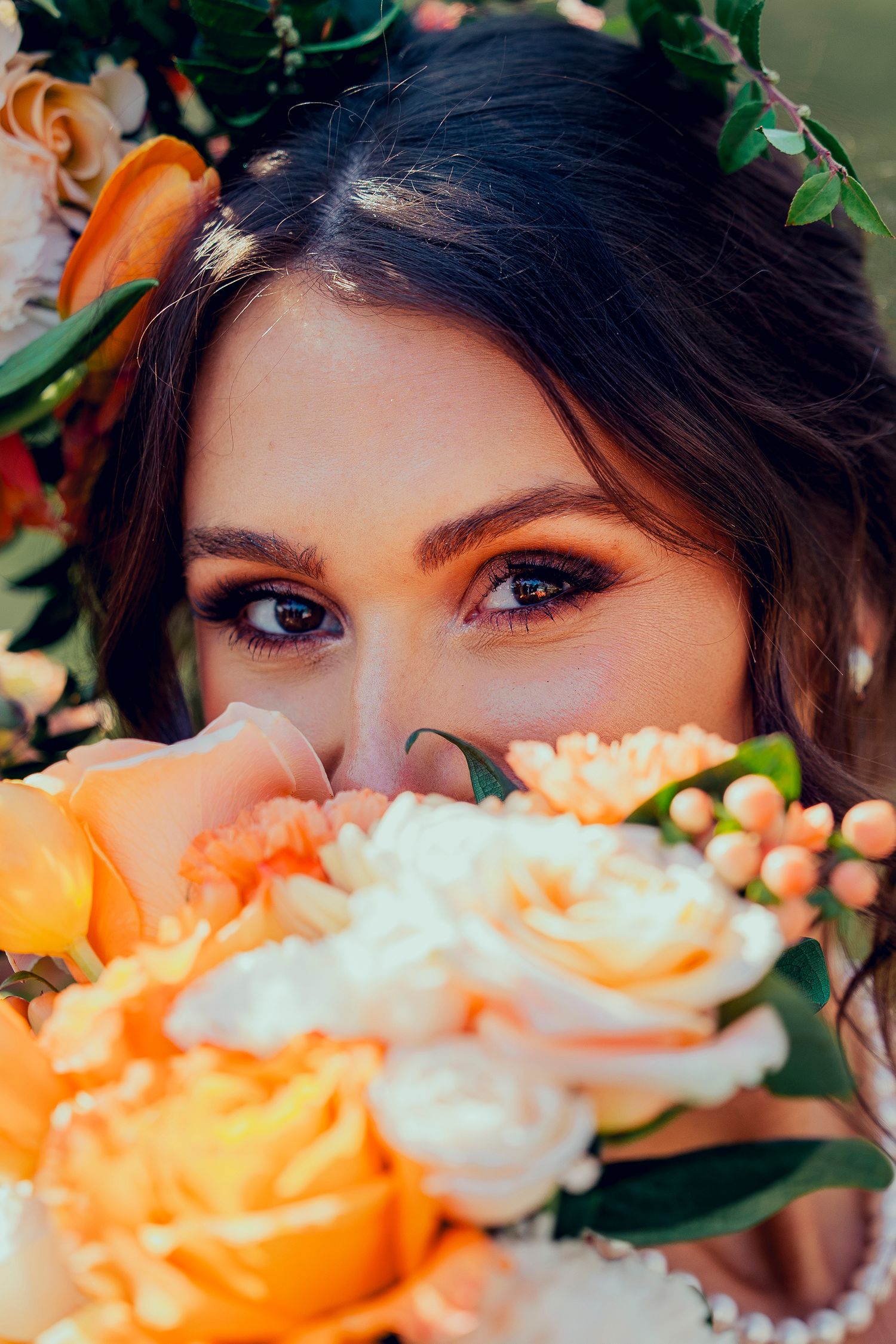 Close up portrait with peach and white roses creating a romantic floral frame composition.