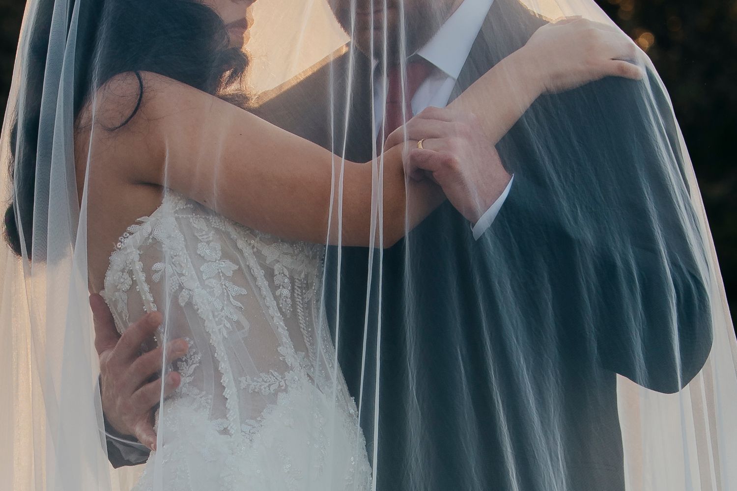 Bride and groom share an intimate moment during their first dance at an elegant wedding reception.