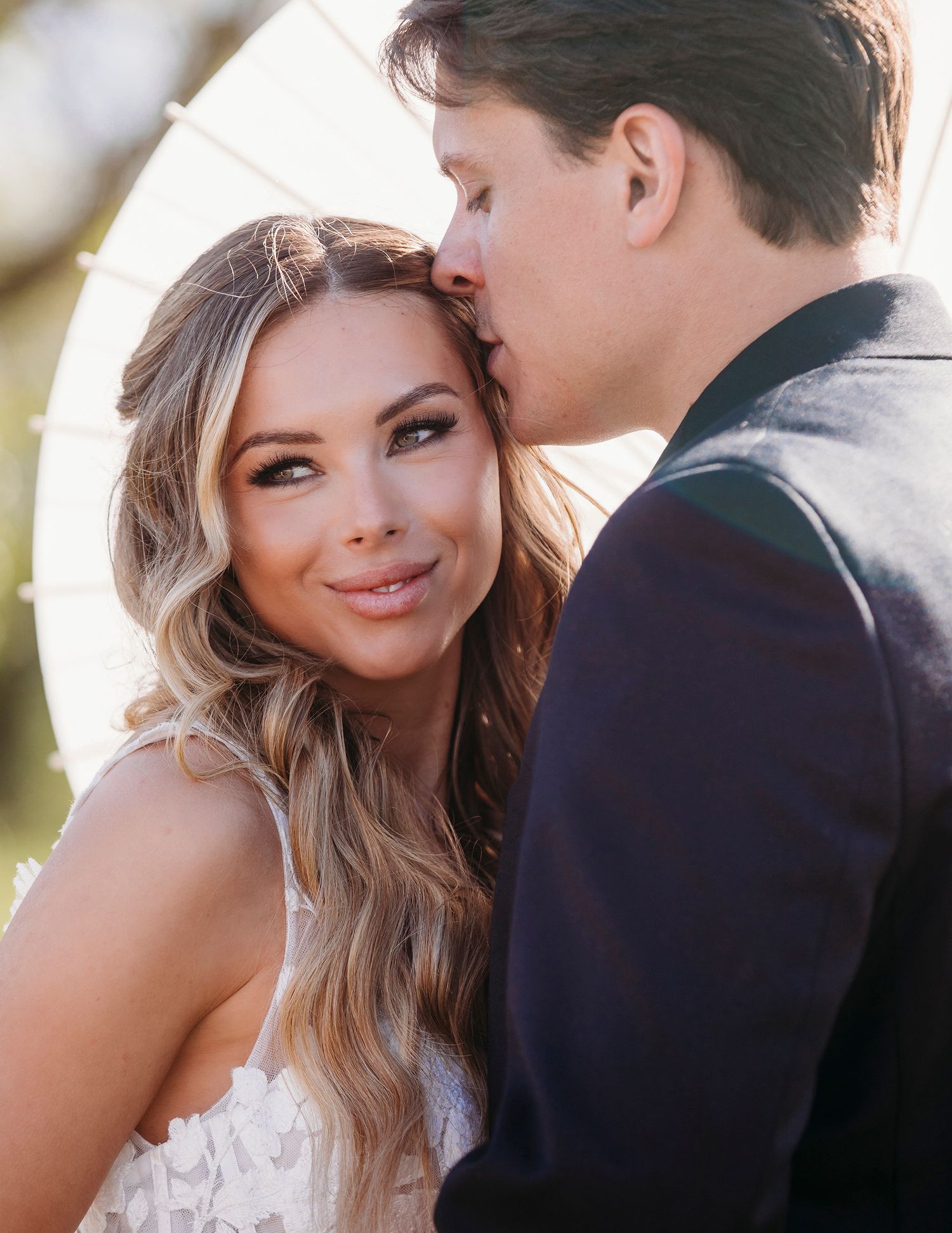 Romantic couple shares intimate moments in a series of four wedding photos outdoors.