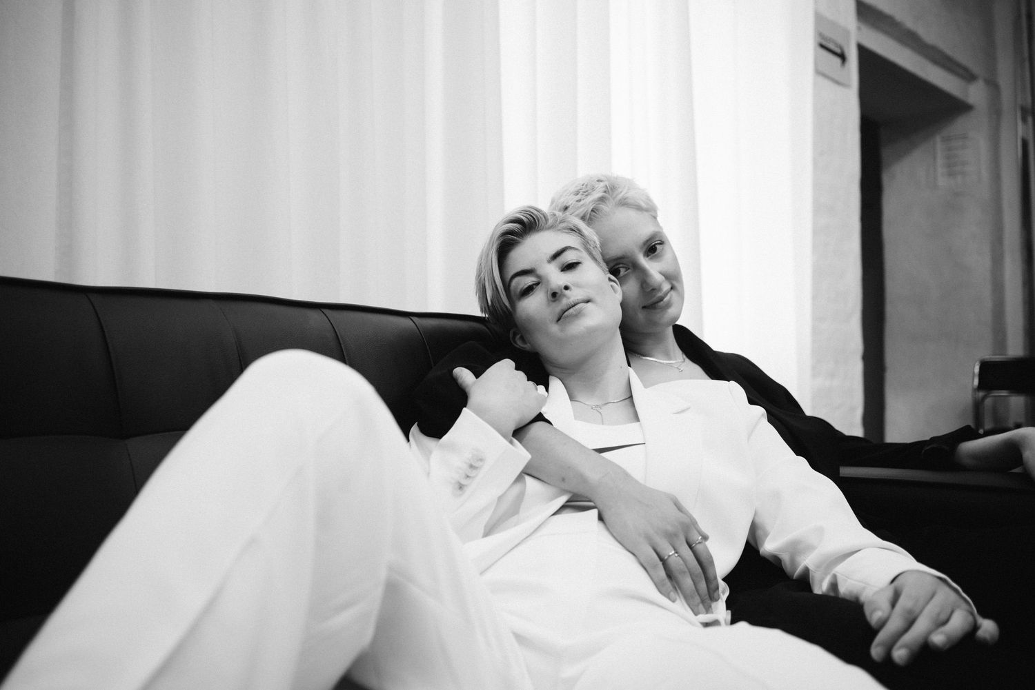 natural moment LGBTQ+ couple embracing engagement photoshoot Berlin