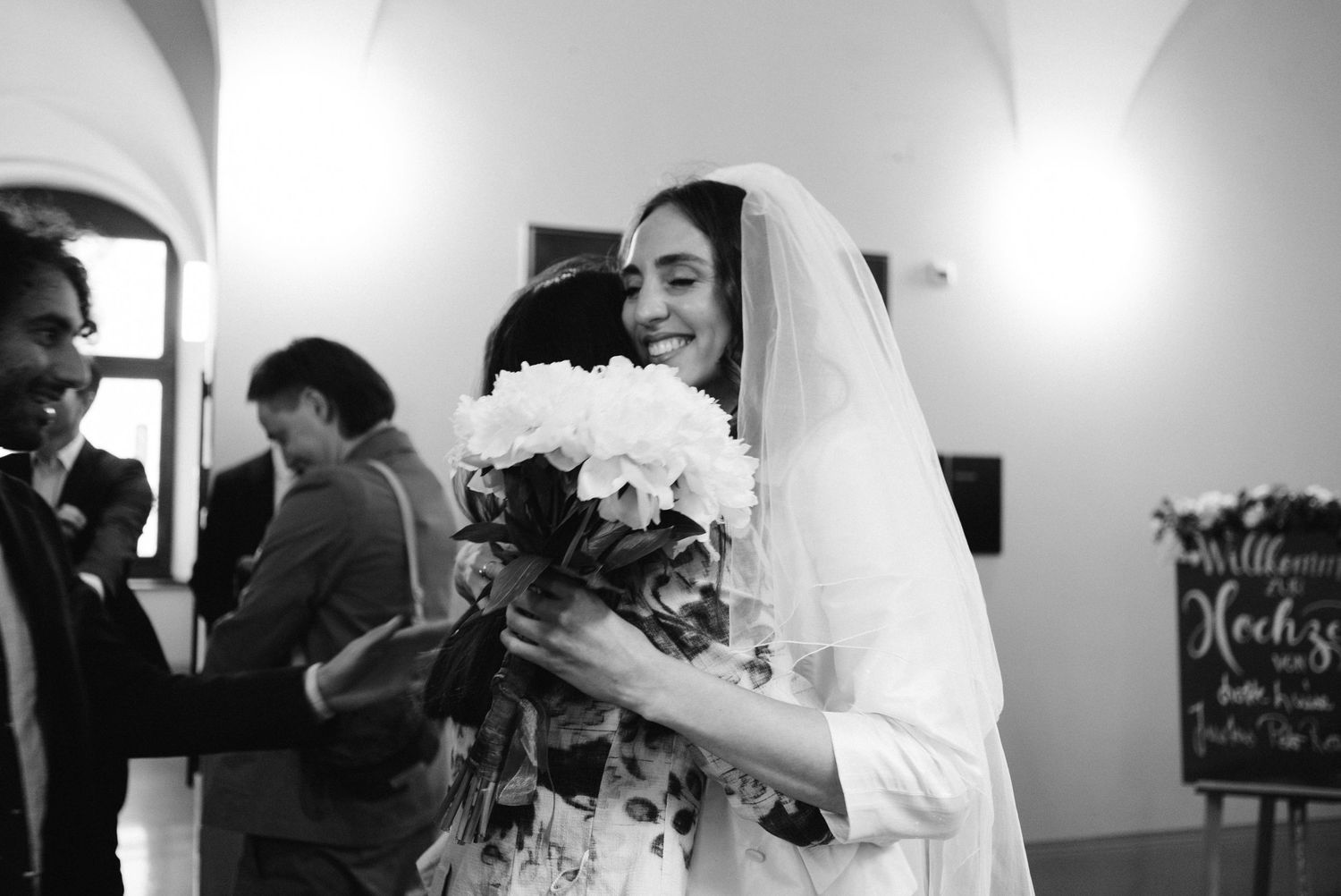 bride candid moment hugging friend civil ceremony