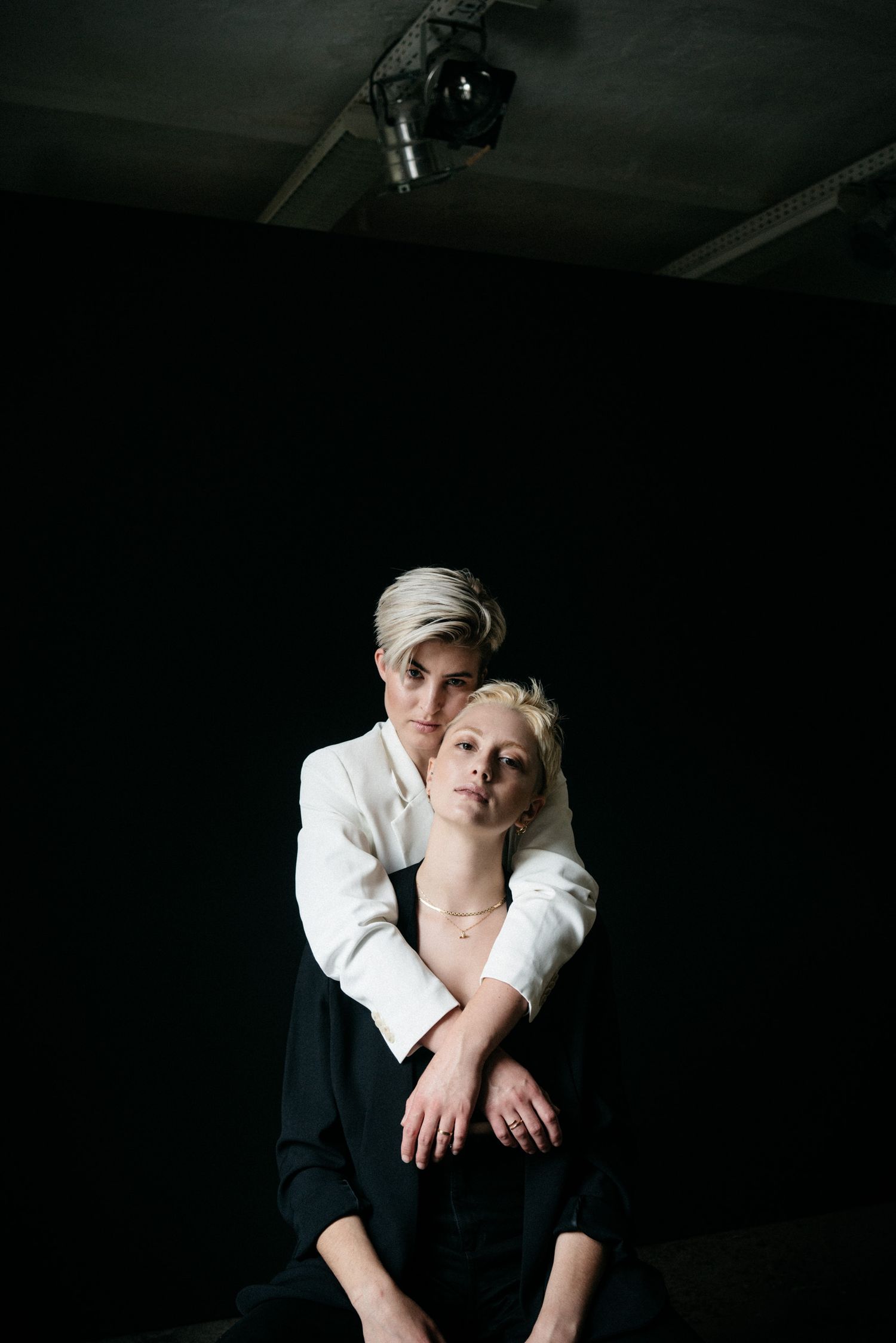 queer couple embracing in minimalistic photoshoot in Berlin