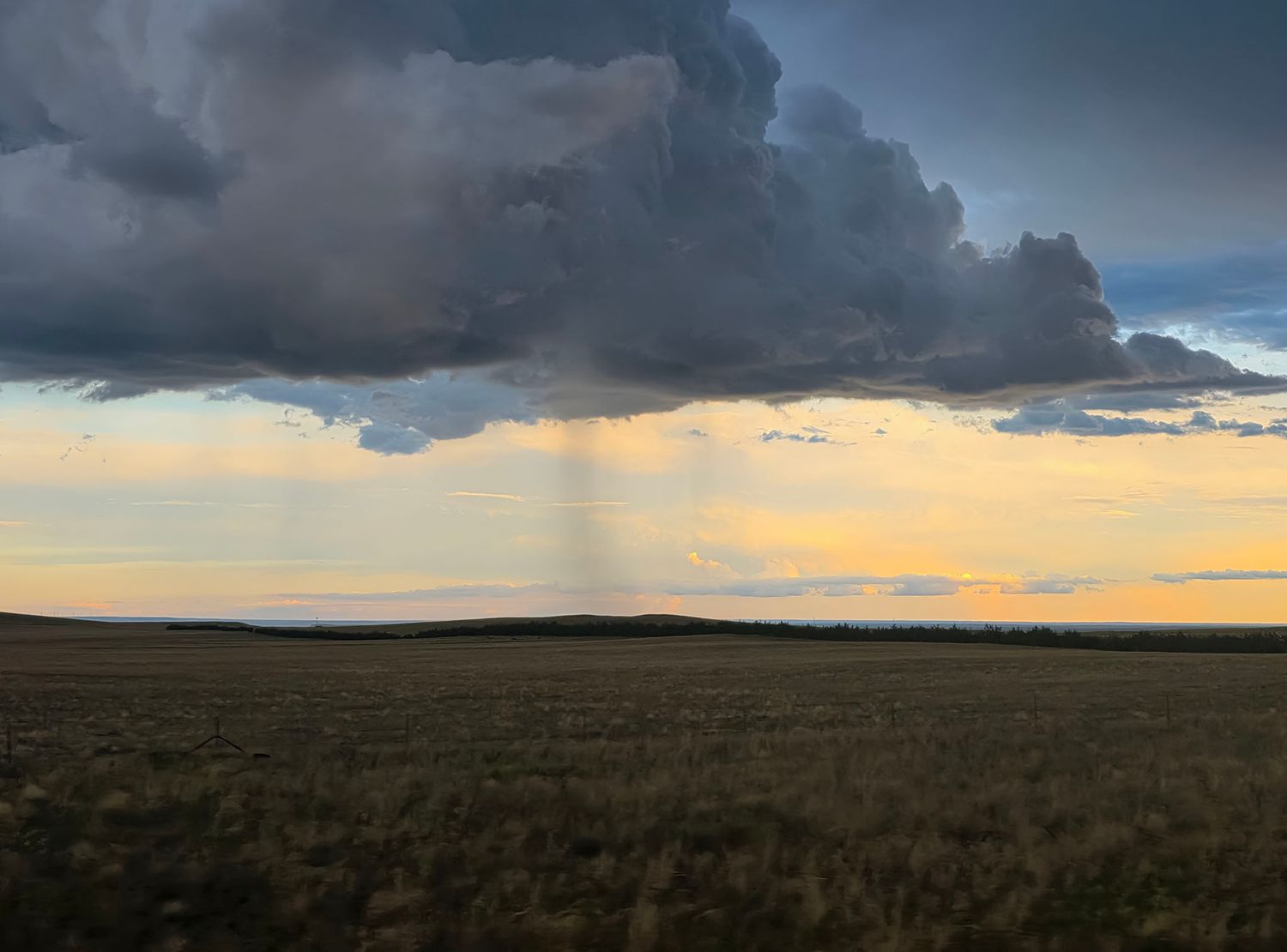 Dark storm clouds over the western Nebraska prairie at sunset