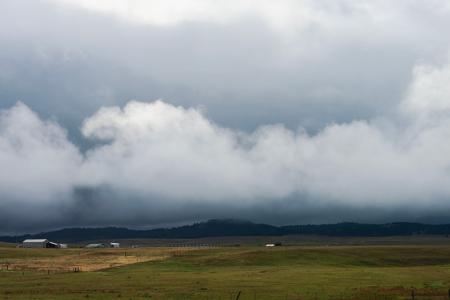 Low storm clouds rolling over open grassland in South Dakota