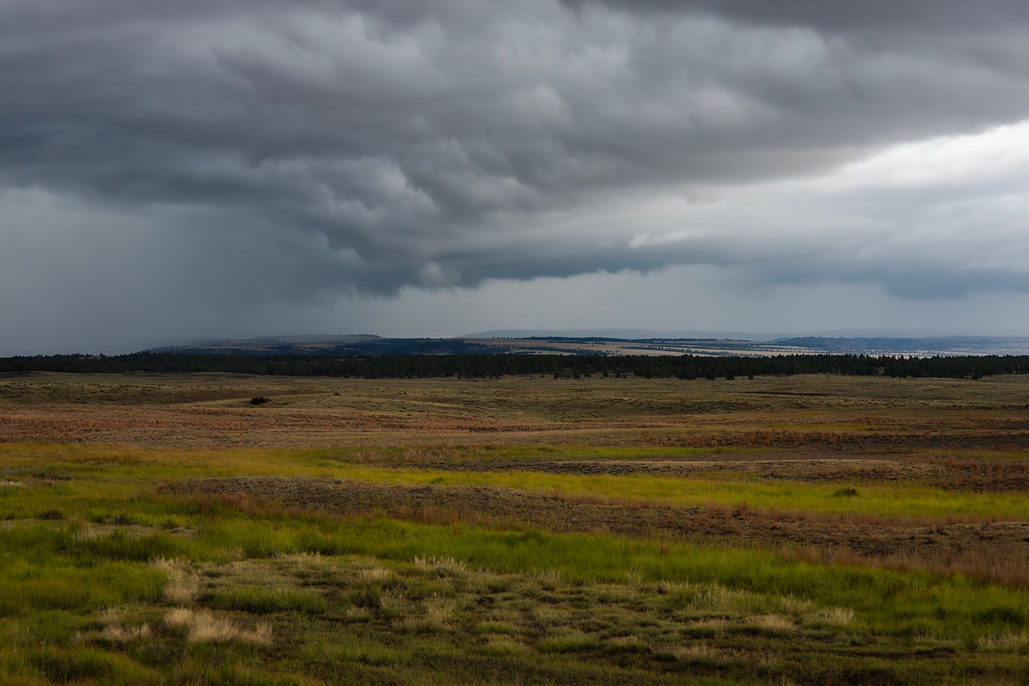 Dramatic Midwestern storm clouds over rolling prairie and open fields
