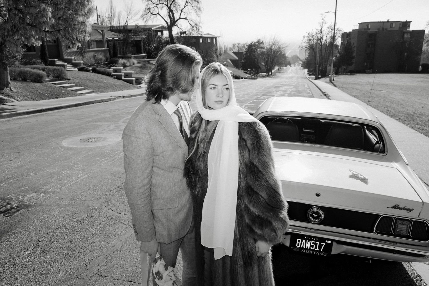 A series of vintage black and white photographs showing people and classic cars from the 1960s era.