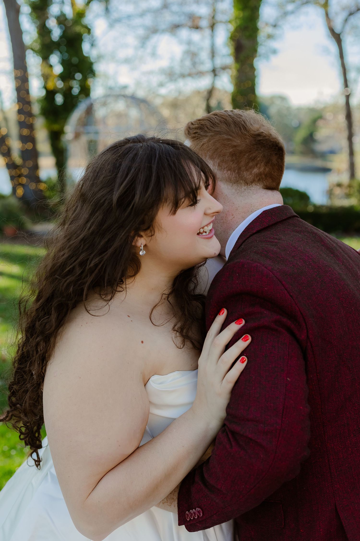 A romantic wedding couple shares intimate kisses in a series of outdoor portraits with trees in the background.