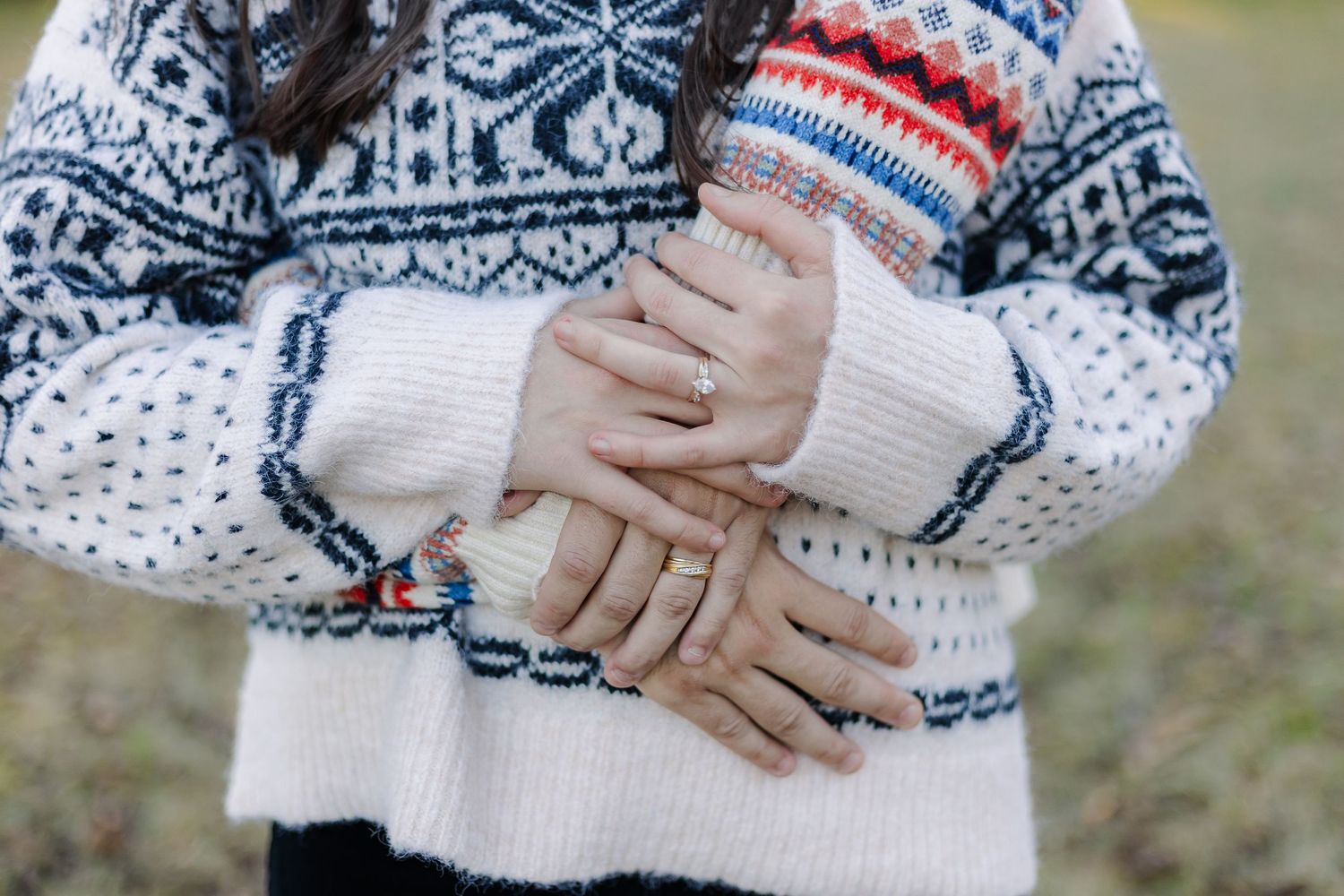 Close-up details of a cozy Nordic-style winter sweater with traditional blue and white snowflake patterns.