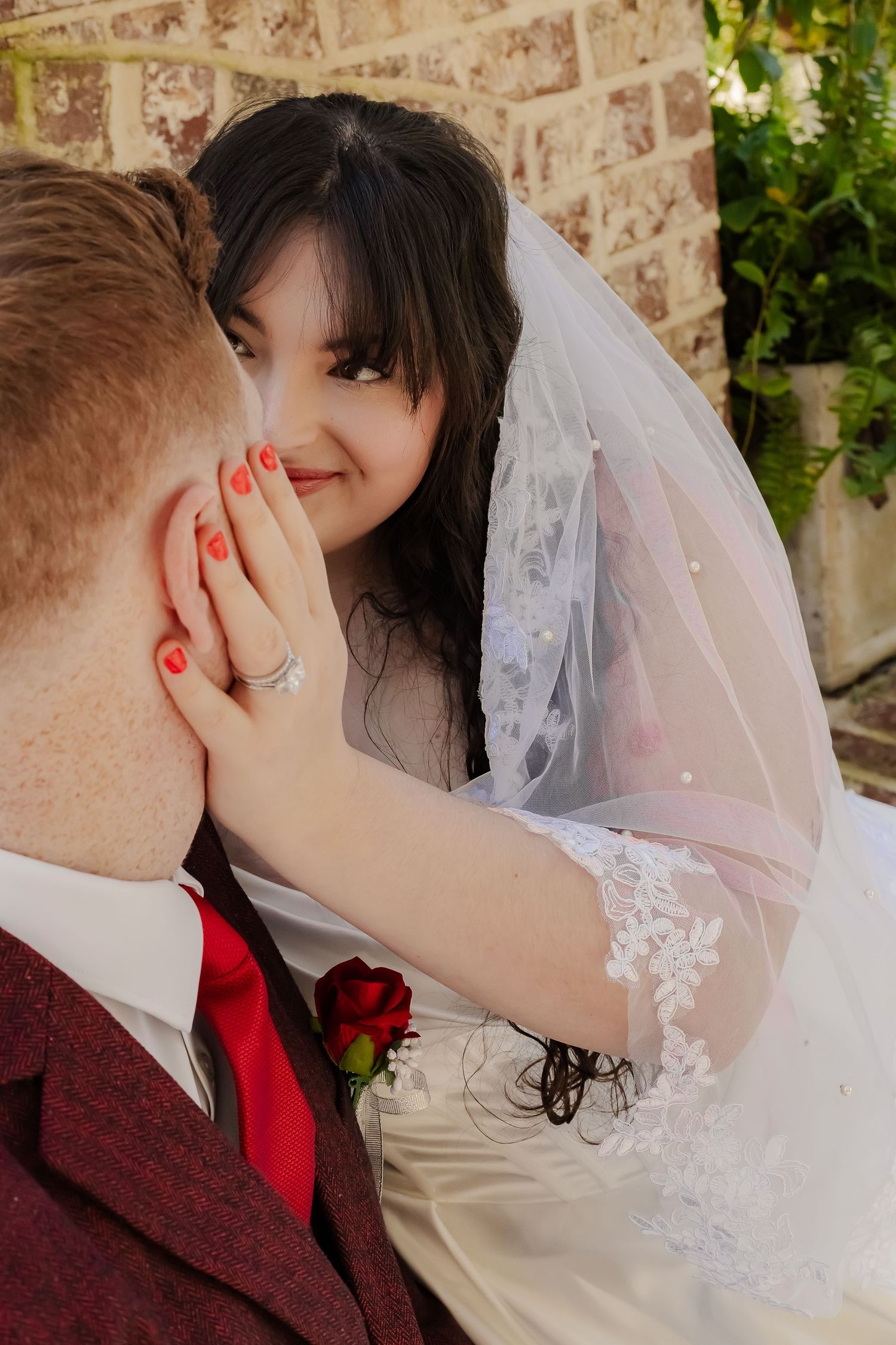 A romantic sequence of wedding photos showing a couple sharing a tender kiss against a brick wall background.