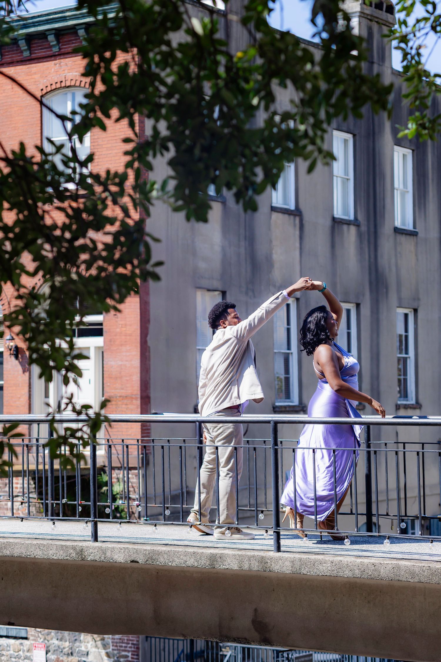 A sequence of four action shots showing a parkour athlete performing a backflip on a concrete wall in an urban setting.