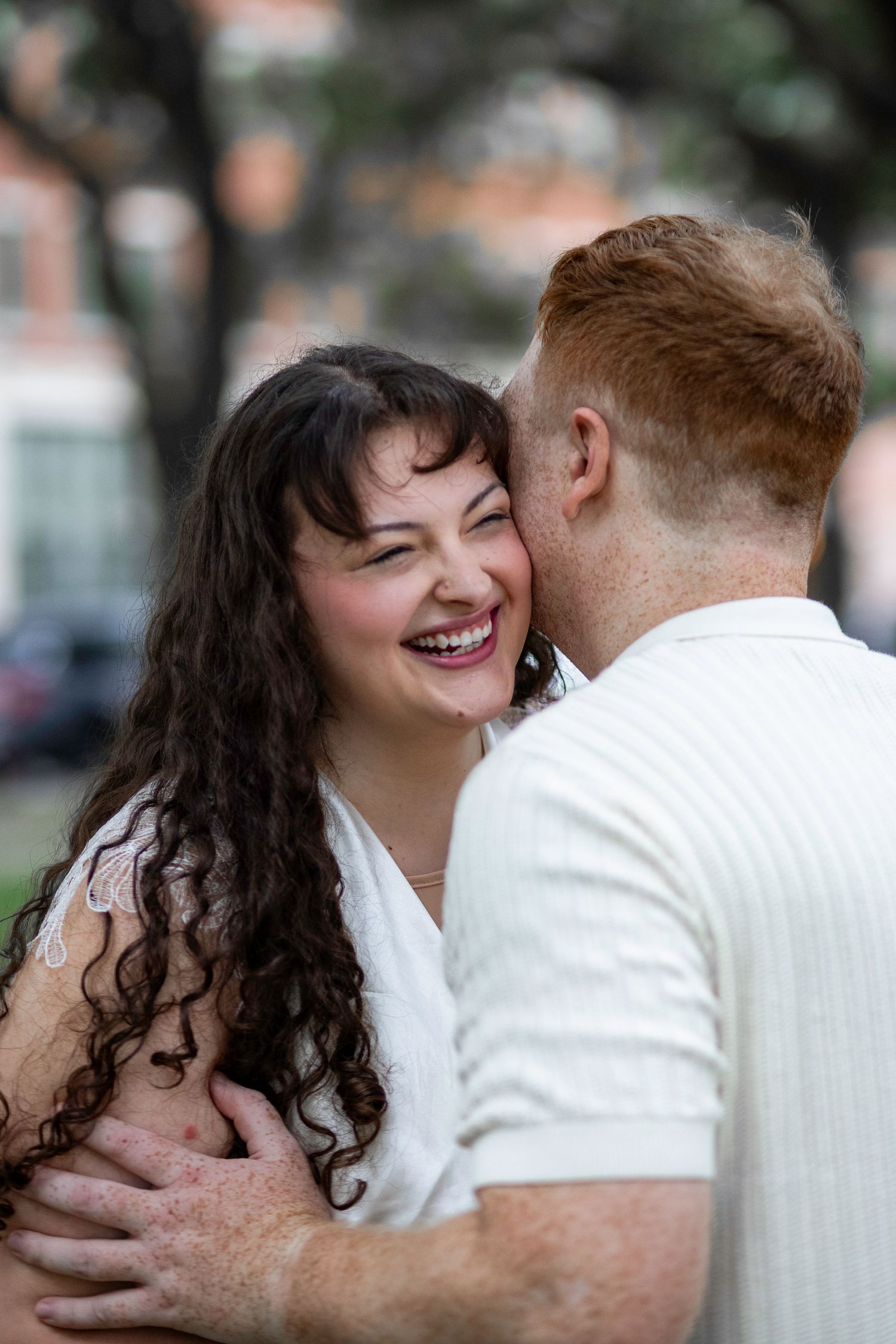 A romantic couple shares an intimate moment together outdoors, expressing joy and affection in a candid photo sequence.