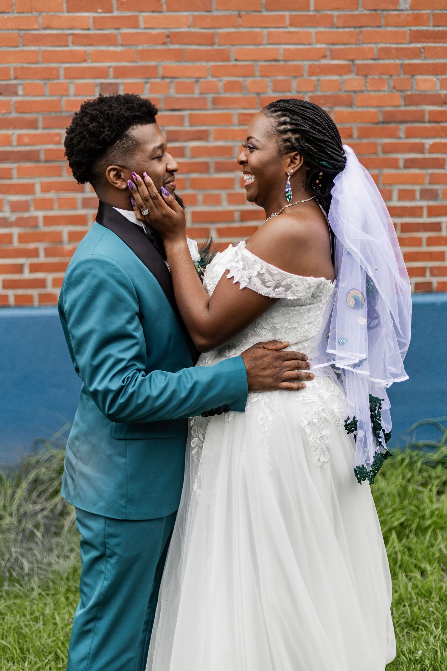 A bride and groom share a romantic moment against a brick wall backdrop in a series of candid wedding photos.