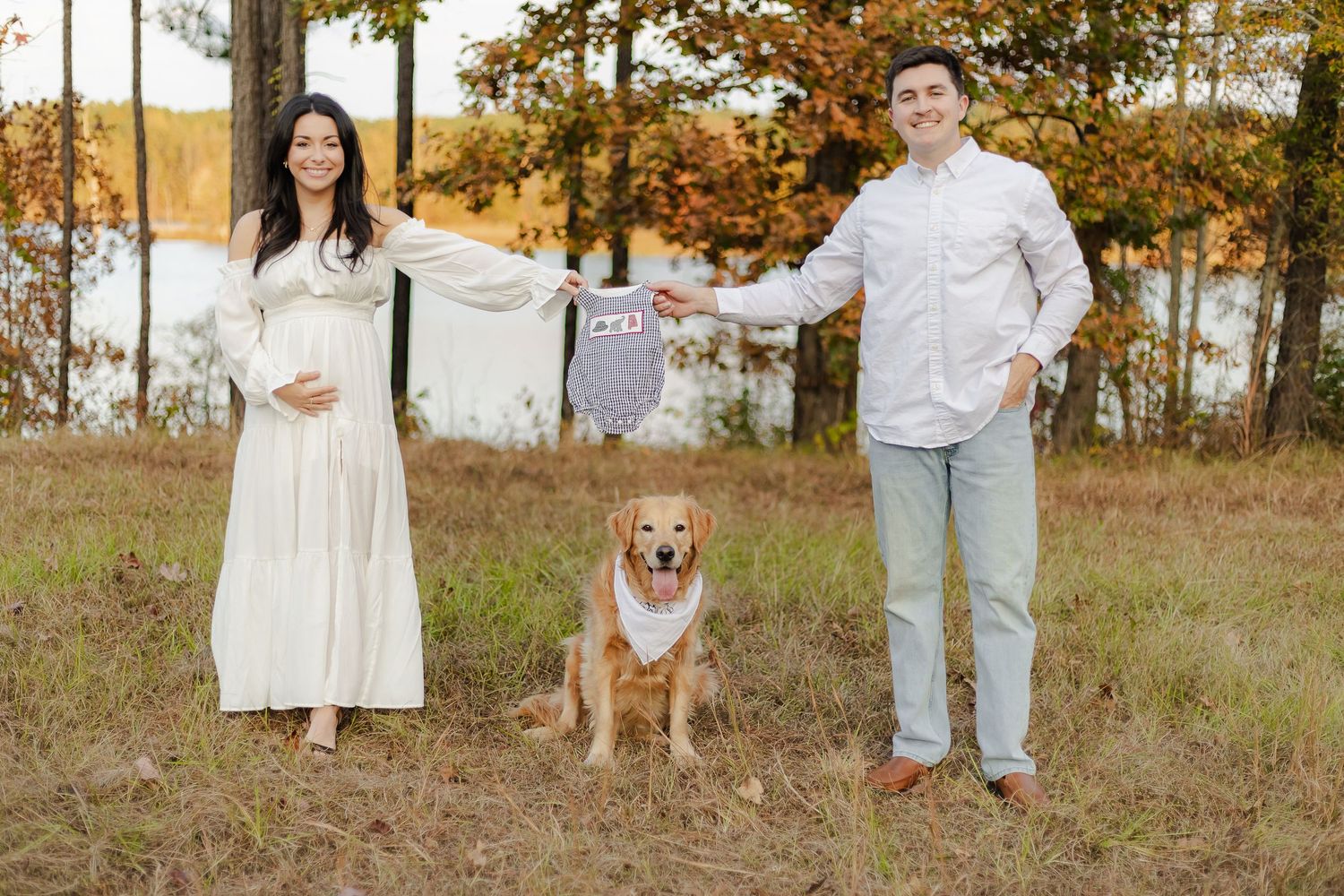 A group wearing white outfits poses in a golden autumn field at sunset with their corgi dog.
