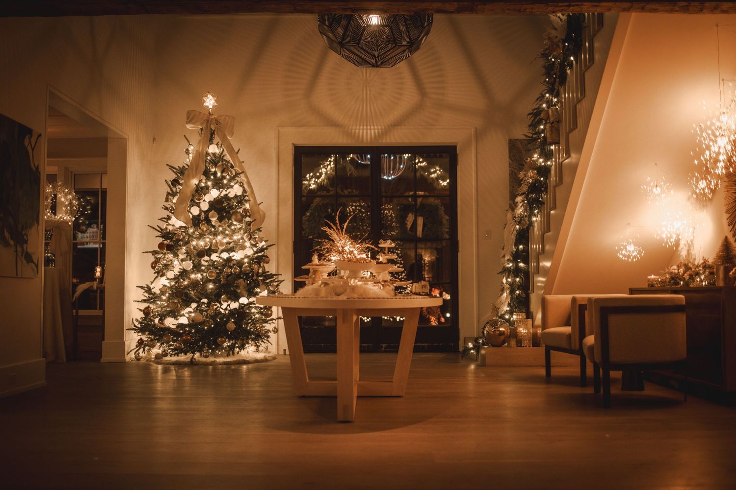 Cozy Christmas living room with decorated tree, fairy lights, and festive garland in warm golden ambiance.