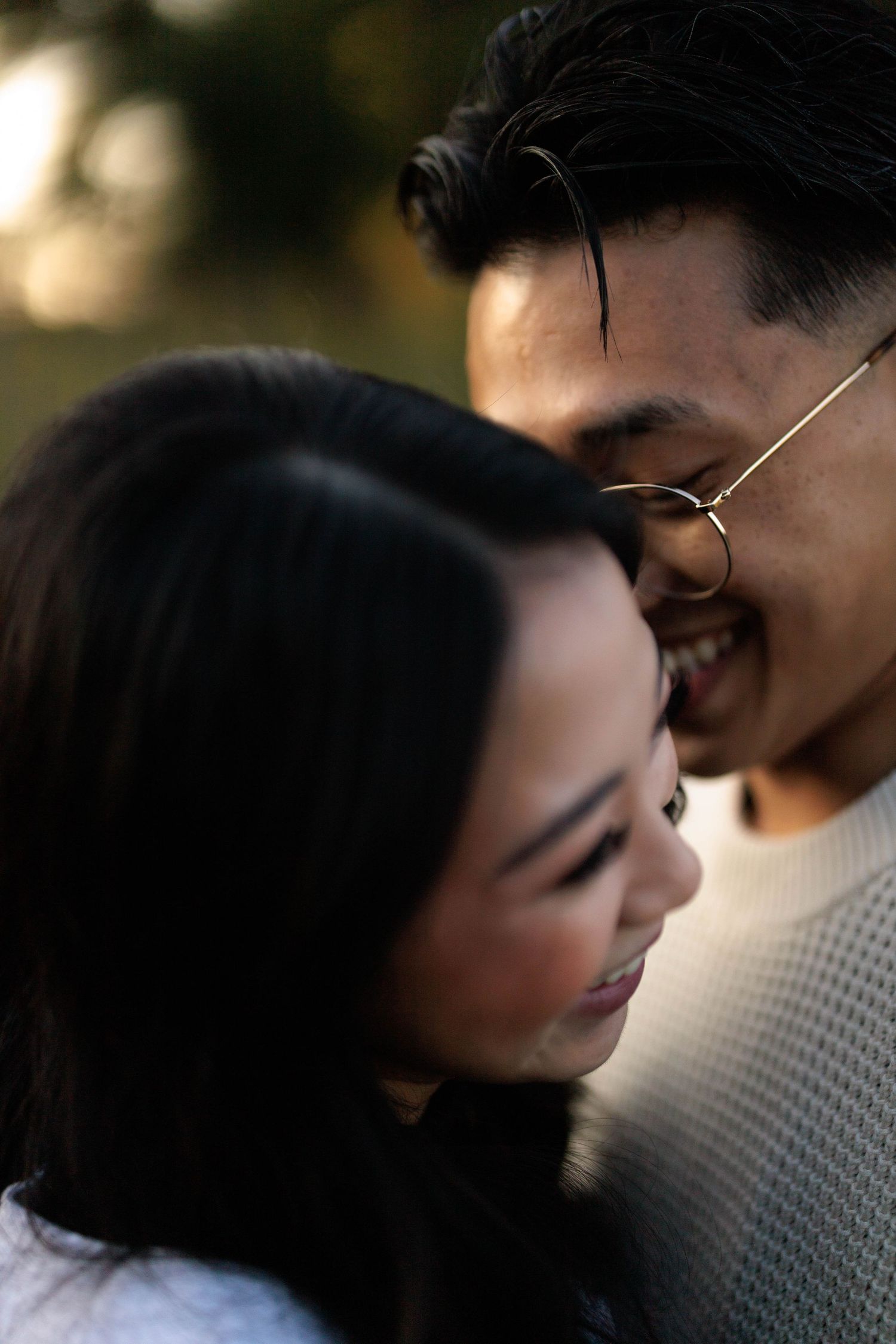 A close-up intimate moment between a couple in soft lighting, creating a warm and romantic atmosphere.