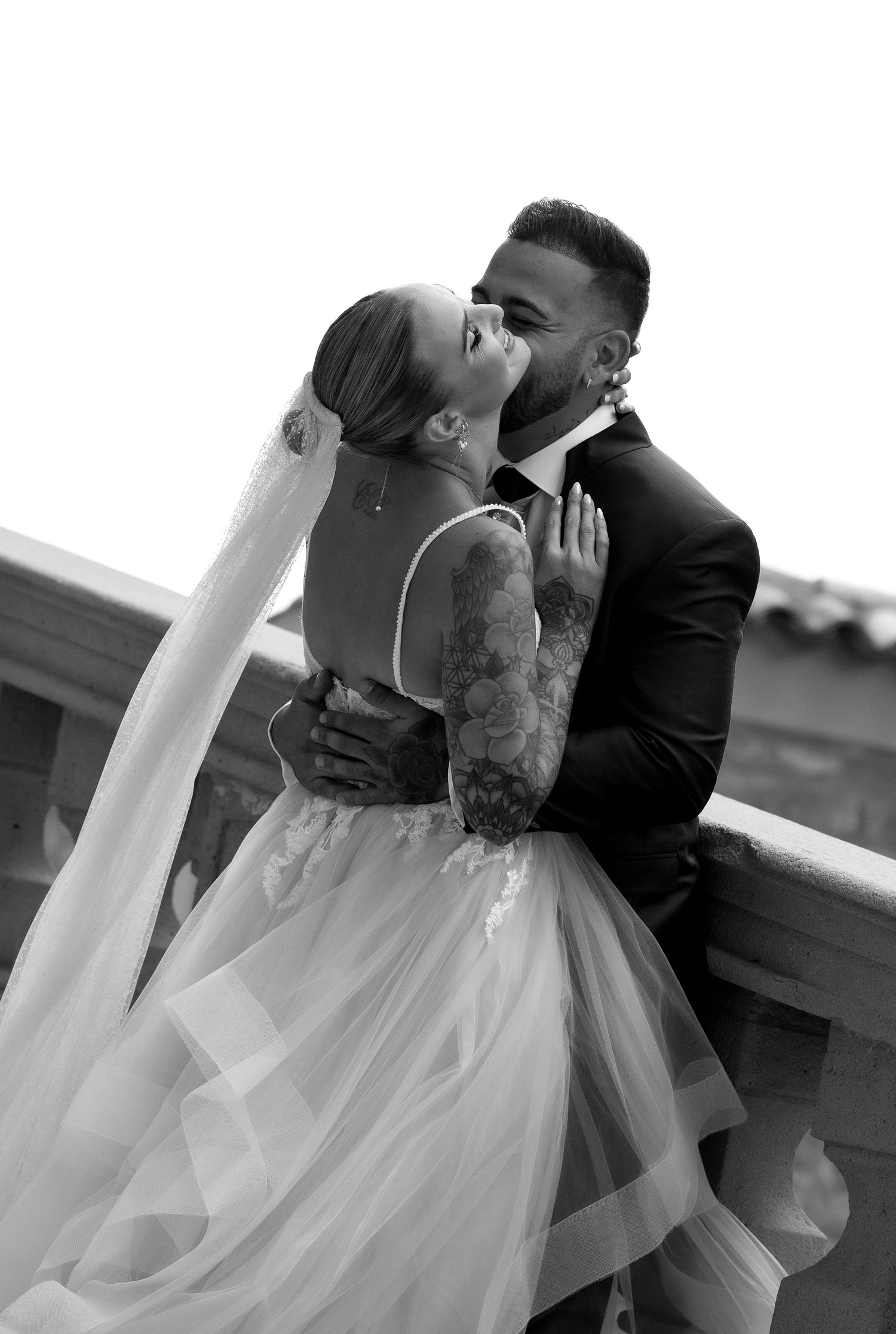 Black and white sequence capturing intimate wedding moments with flowing veil details.