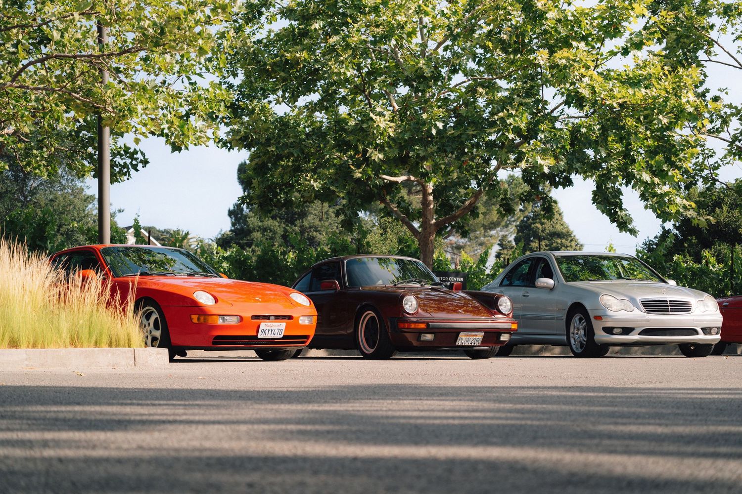 The C32 AMG parked along a row of Porsche's at Breakfast Club Rally.