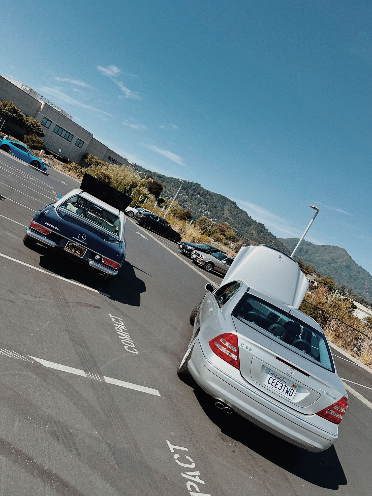 c32 AMG parked along side a Mercedes-Benz Pagoda coupe.