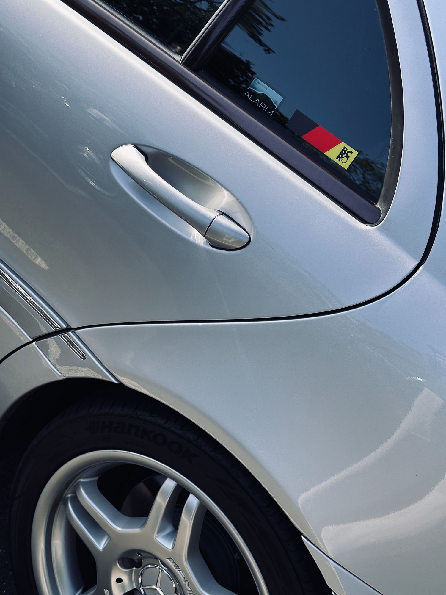 A Breakfast Club Rally decal on the silver 2004 C32 AMG sedan.