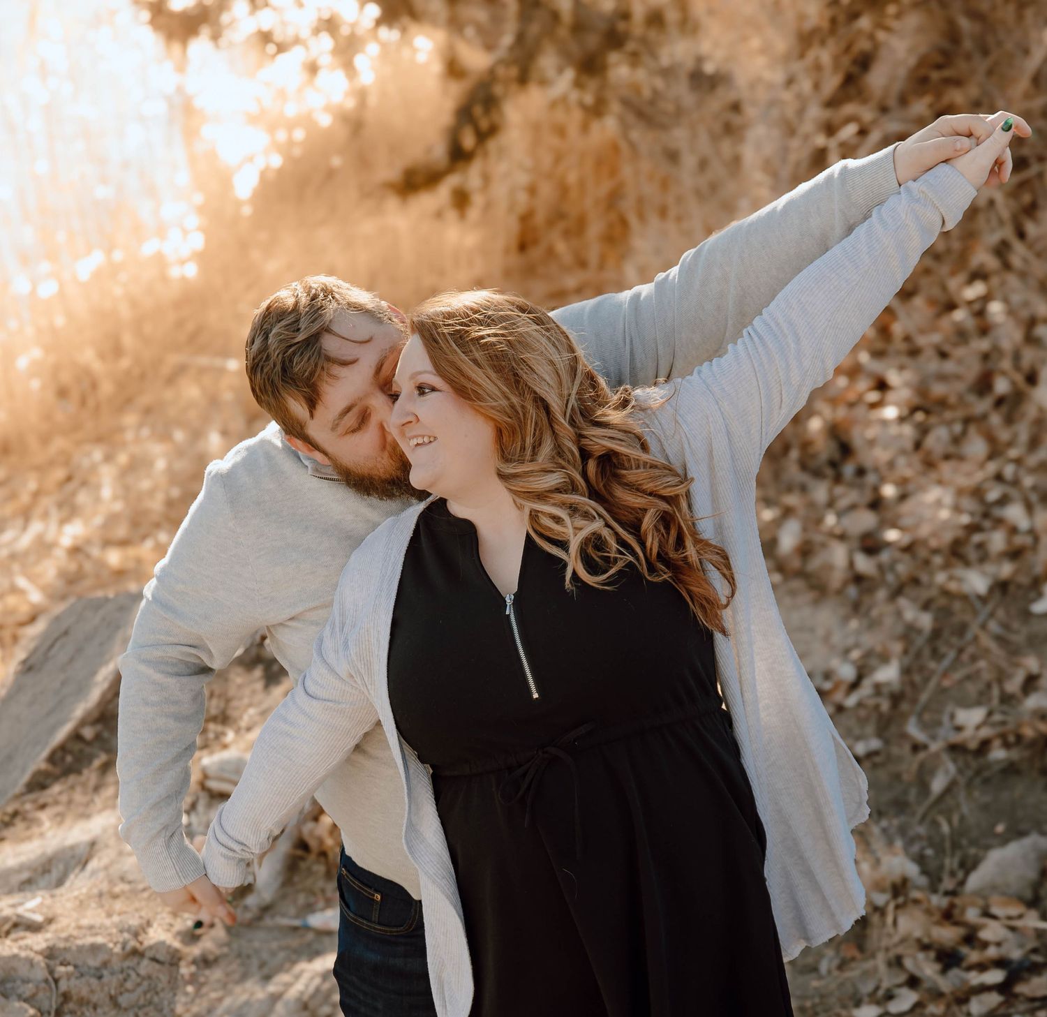 A North Platte, Nebraska lifestyle engagement session couple embracing during golden hour sunset.