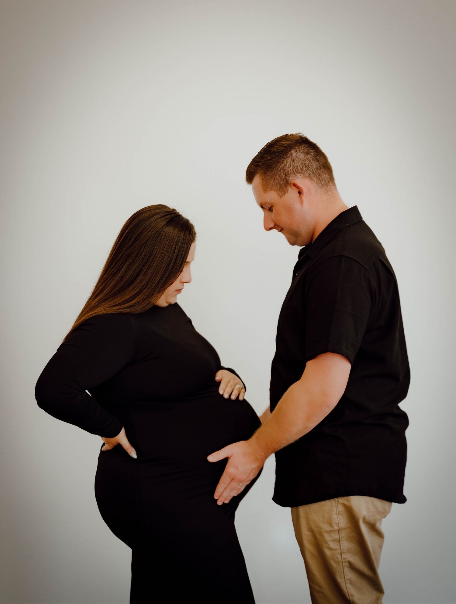 A North Platte, Nebraska lifestyle maternity session couple embracing in studio.