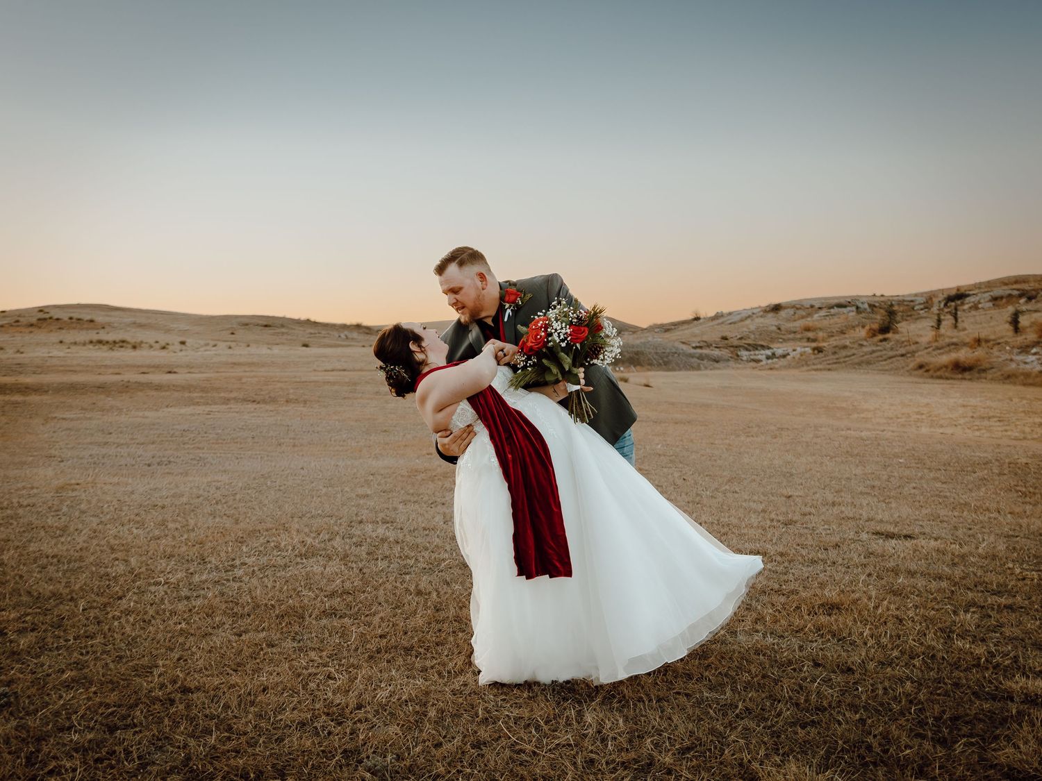A Sidney, Nebraska lifestyle session couple dances together at sunset on their wedding day.