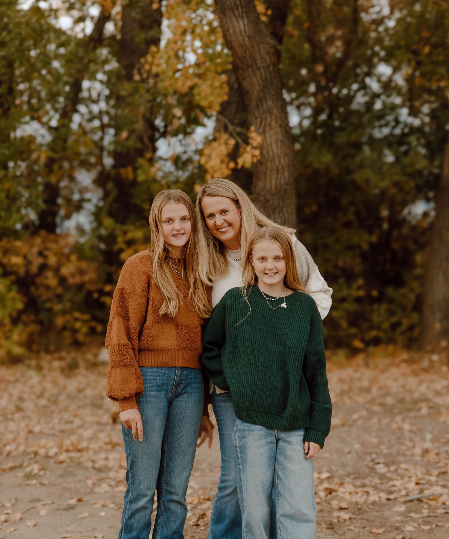 A Sutherland, Nebraska lifestyle family session mom and her daughter's in cozy fall sweaters pose together outdoors
