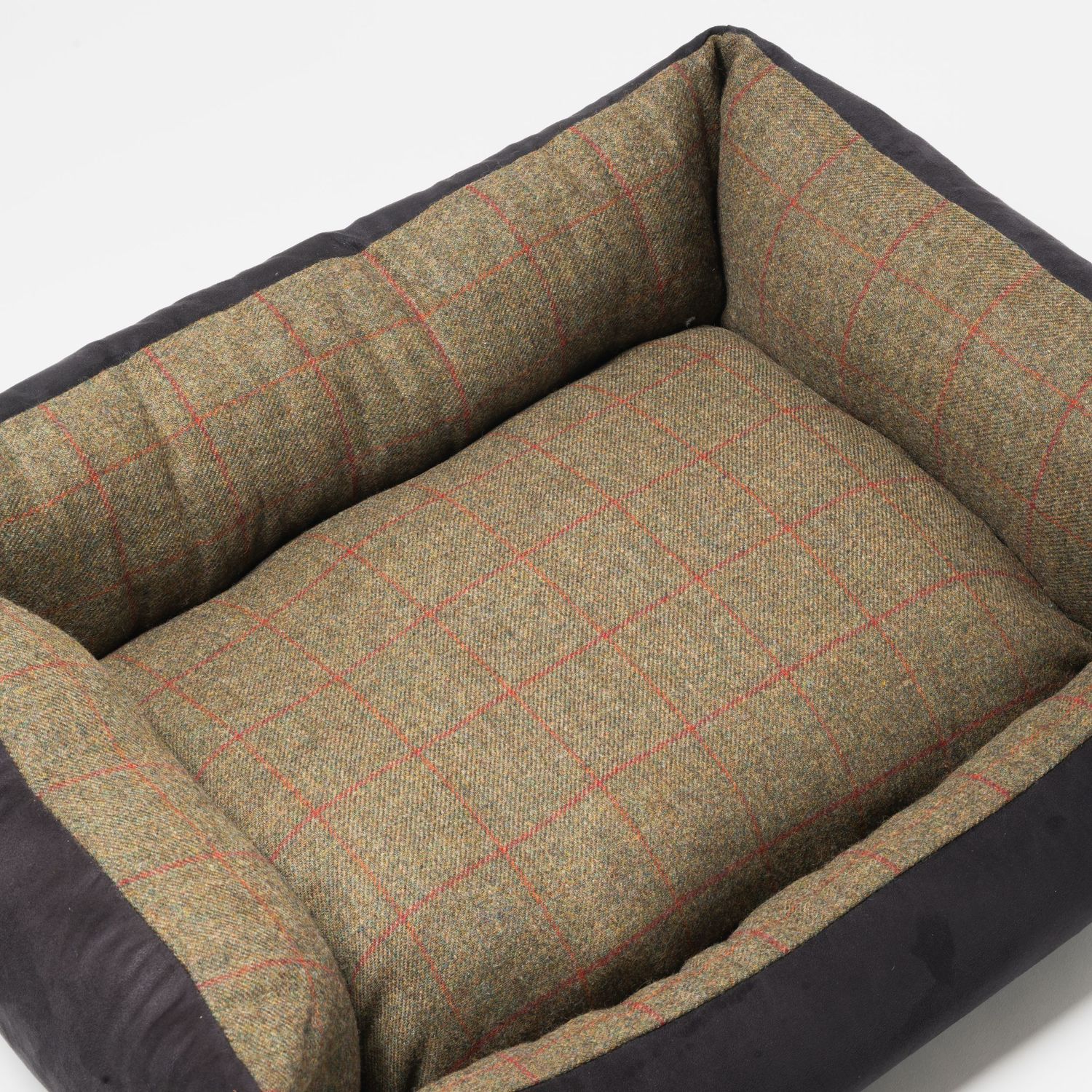 A luxurious pet bed with tweed fabric and dark trim offers a comfortable resting spot. For Ava Innes.