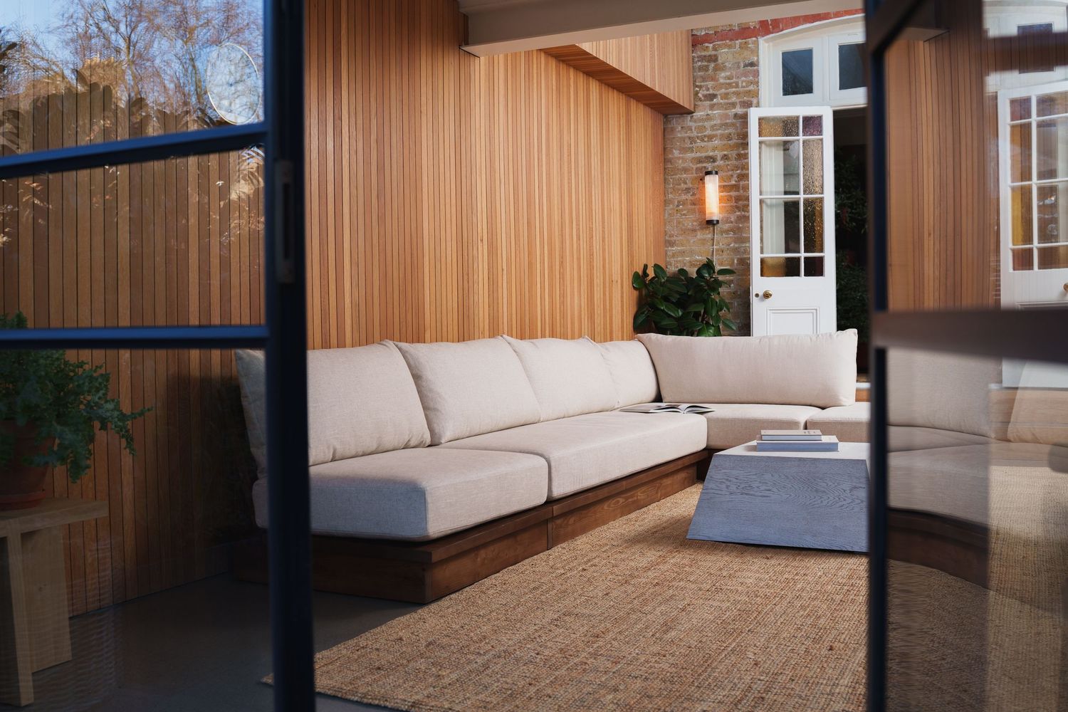Contemporary living space featuring wood paneling and minimalist furniture design. For Superba.