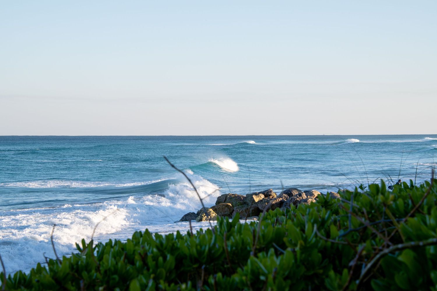 Ocean view in South Florida with waves and coastal greenery