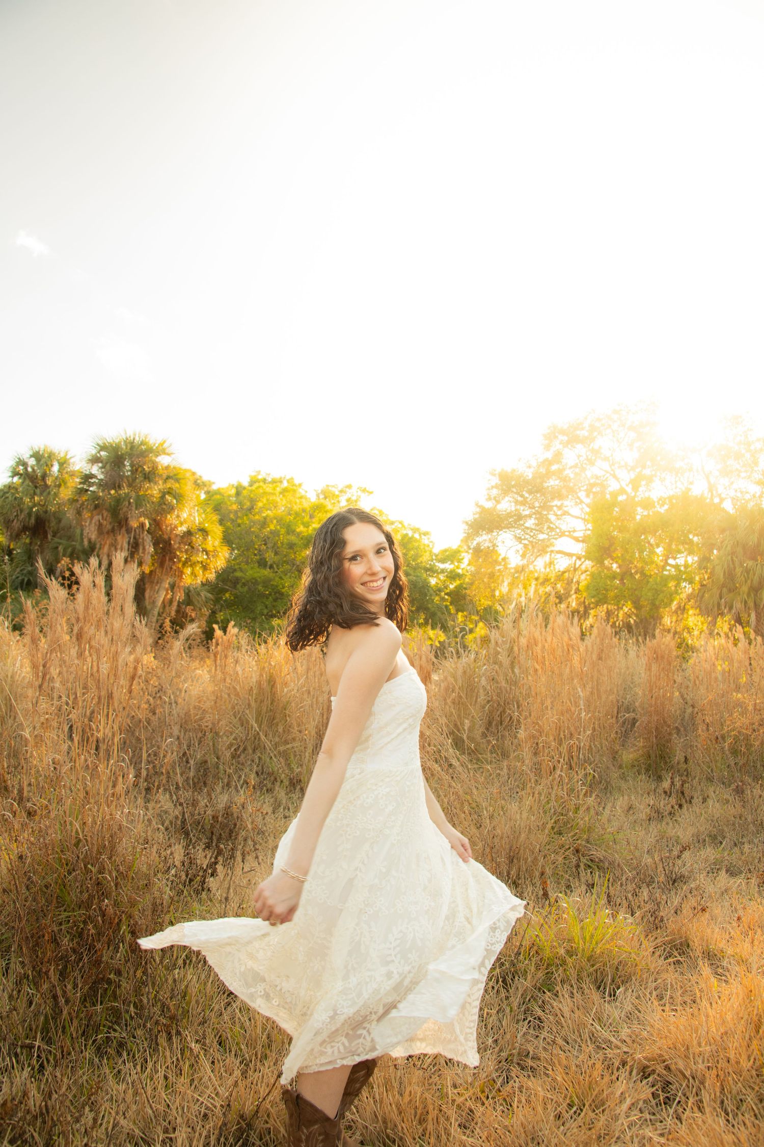 Jupiter senior portraits cowgirl boots dancing in a field