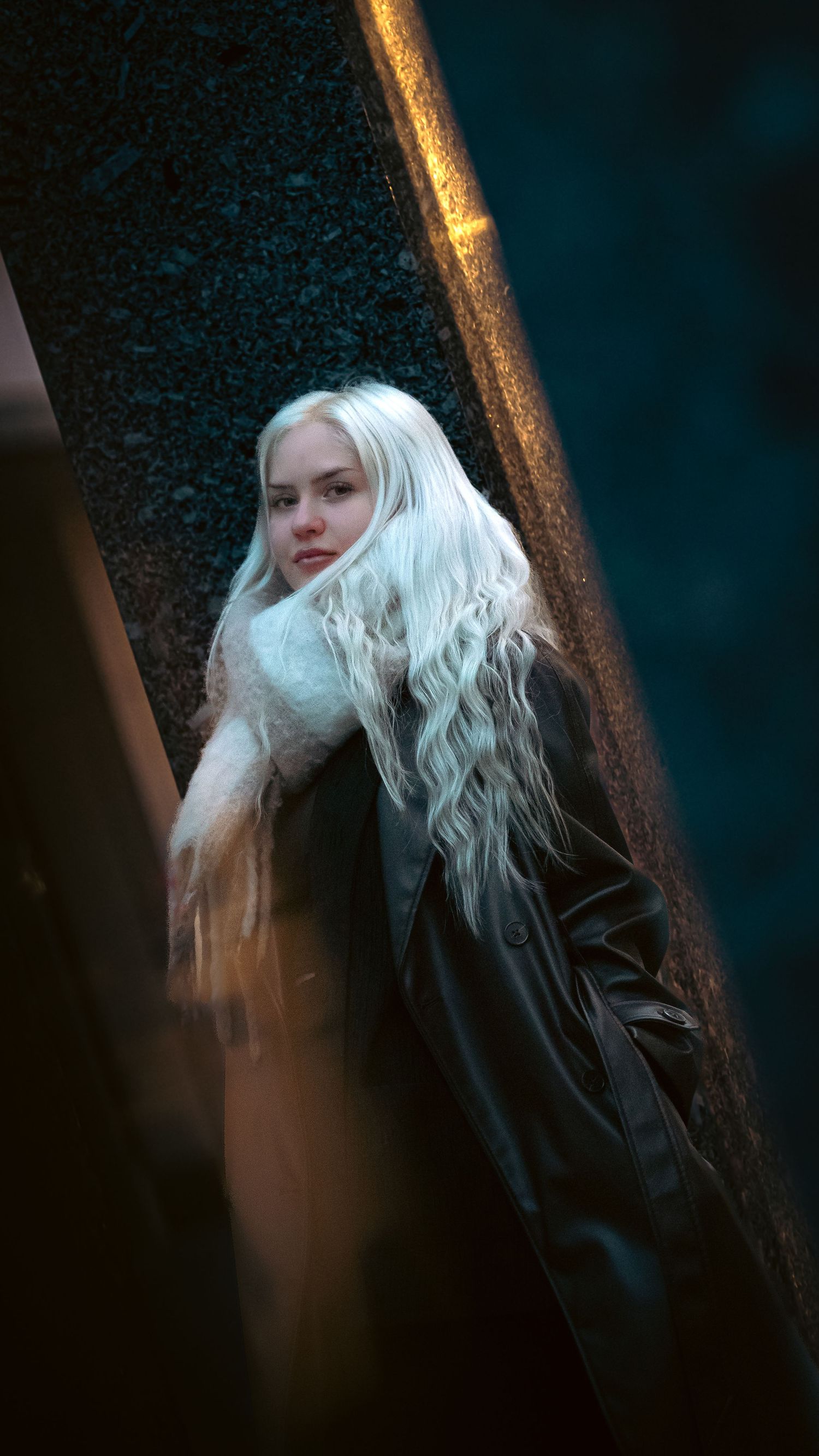 A series of artistic portraits showing platinum blonde hair against a dark background with dramatic lighting.