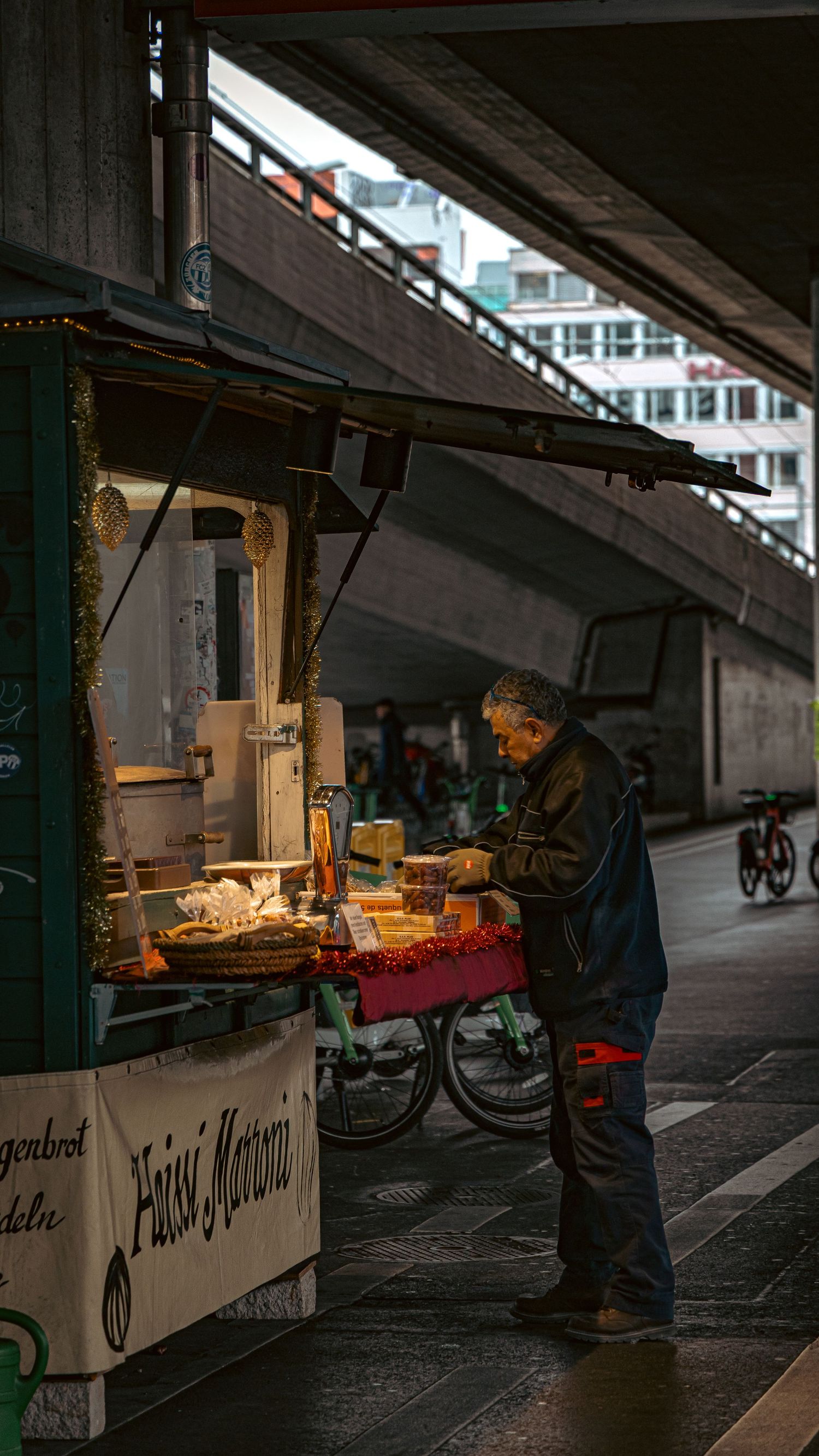 Dark underpass with vendor stalls and dim lighting creating moody atmosphere.
