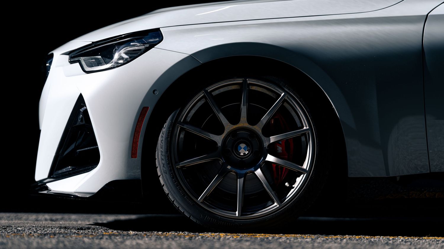 Dramatic rear view of a BMW M car showing distinctive taillights and sporty design elements.