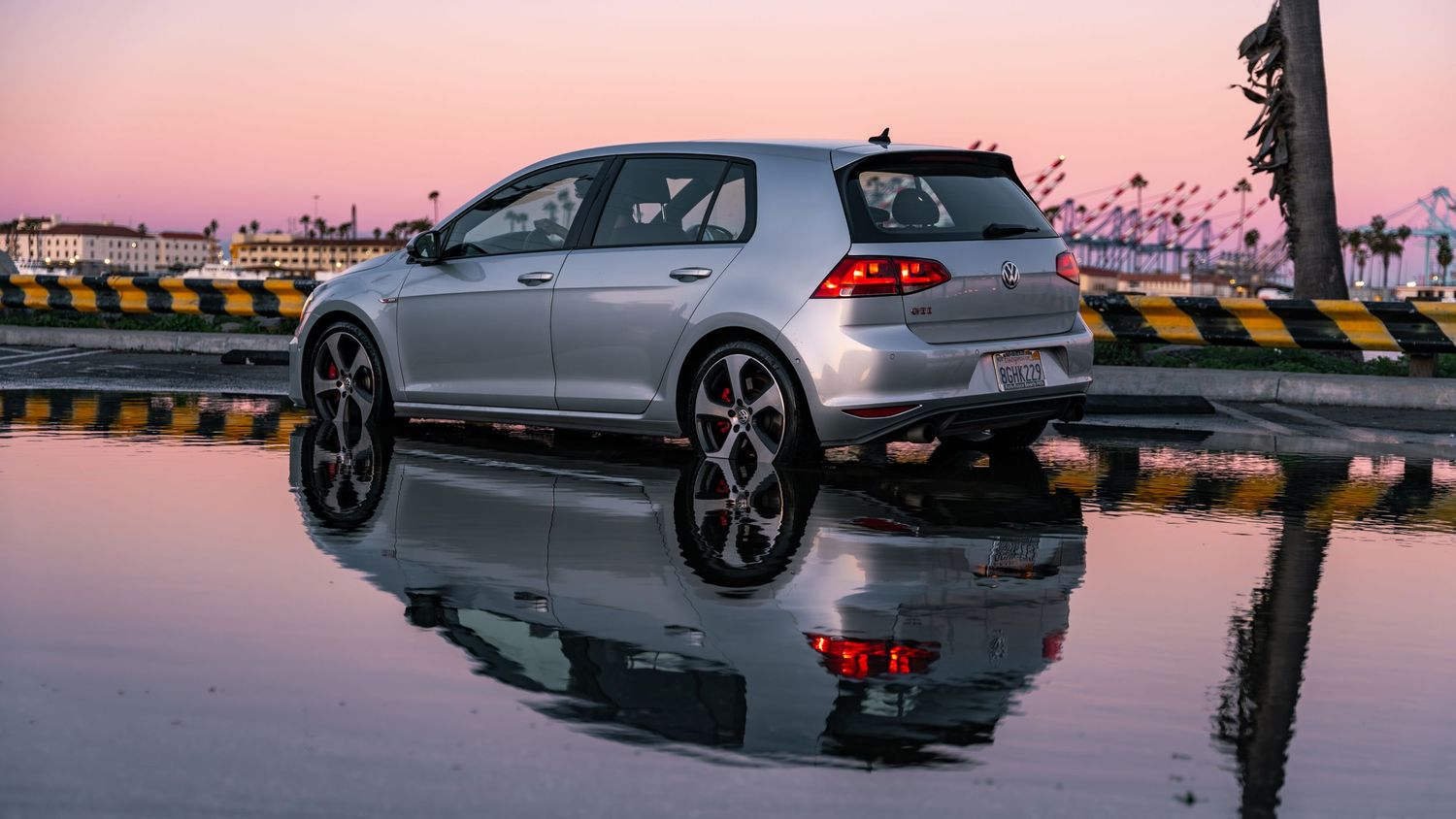 BMW M4 sports car photographed during sunset with dramatic lighting and reflections.