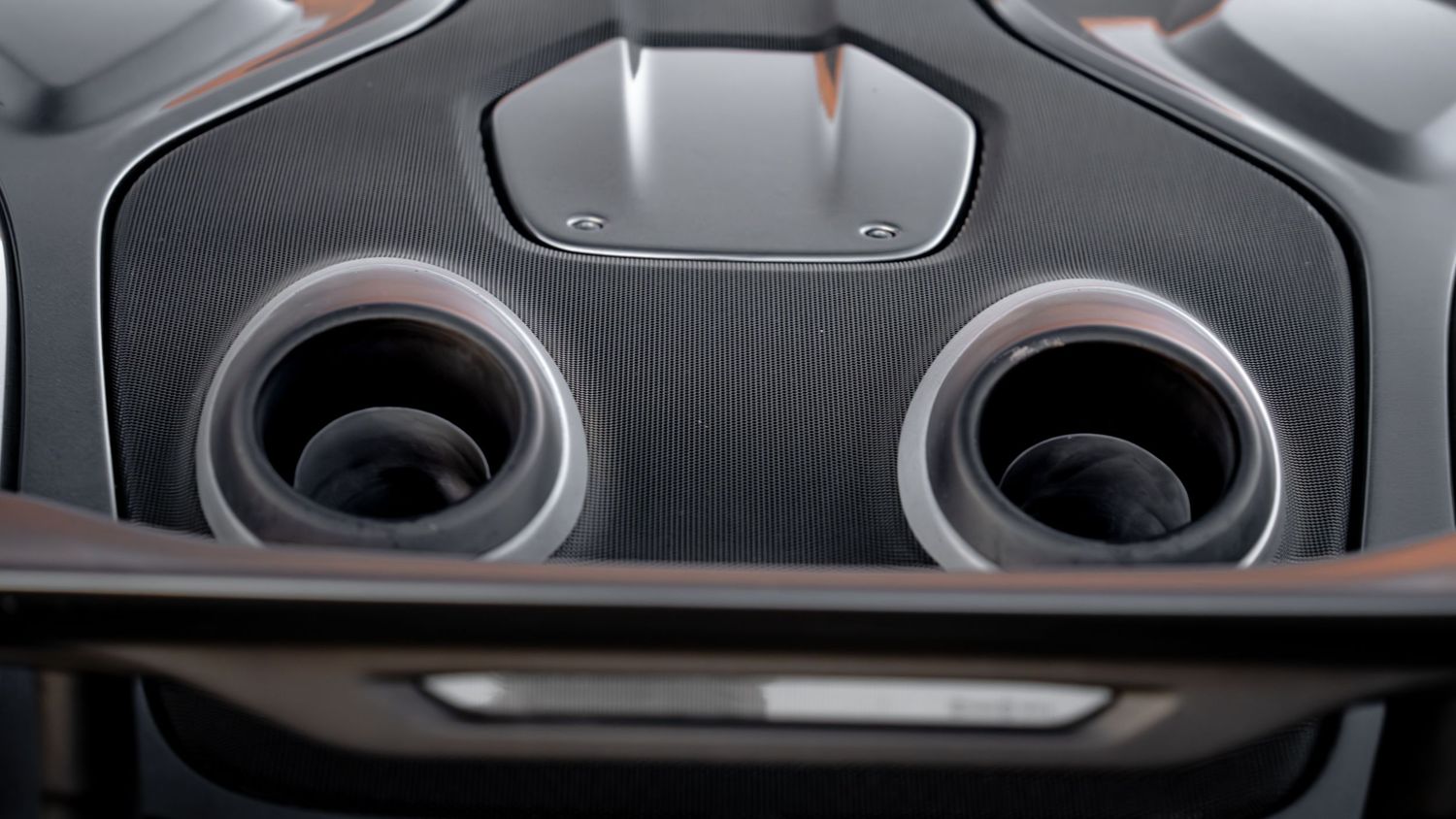 Interior detail shots showing air vents and controls of a luxury sports car.