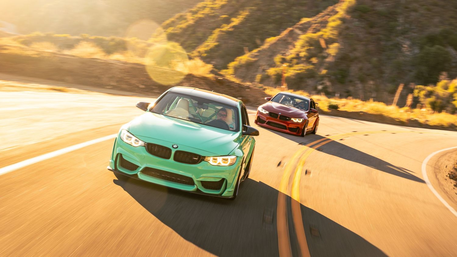 Rolling shots of BMW M3s in mint green and burgundy colors during sunset.
