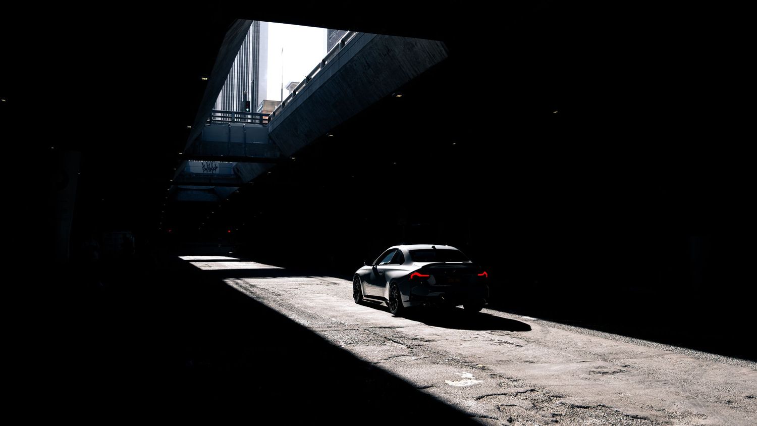 Artistic wide shots of a BMW vehicle in dramatic low-key lighting conditions.